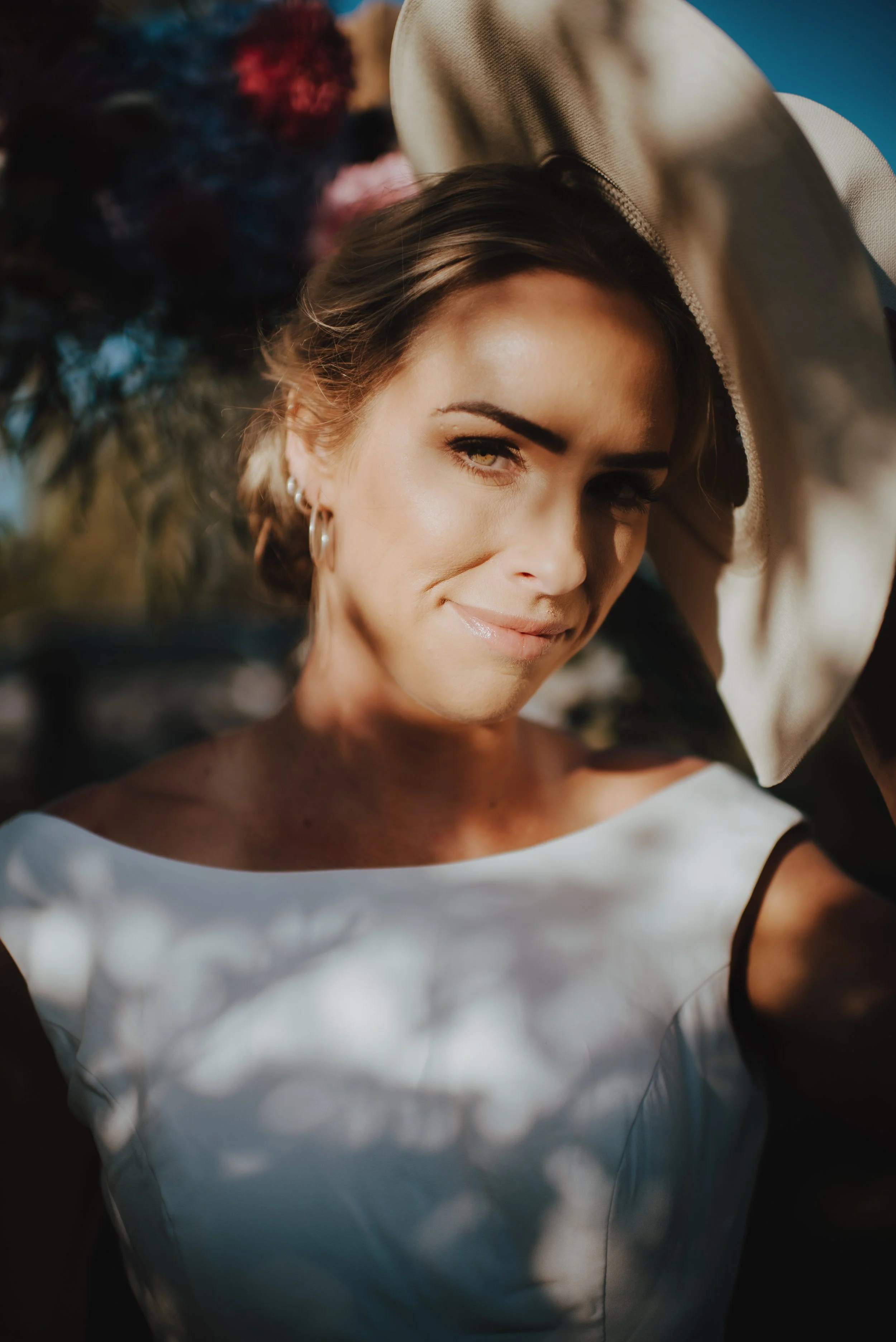 soft and romantic headshot of bride with western hat