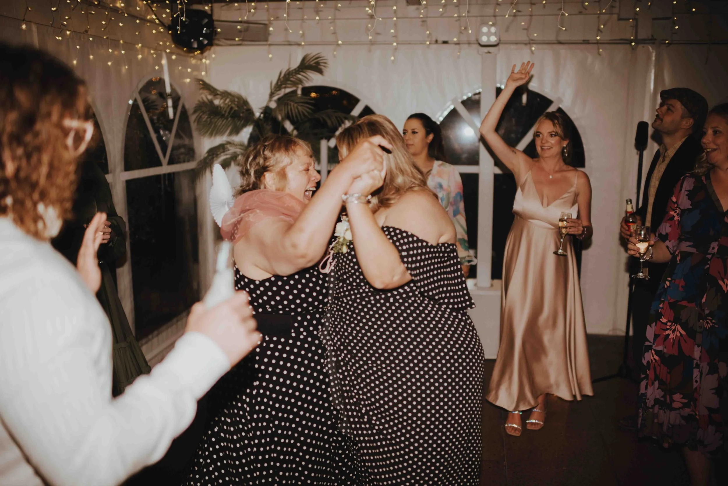 guests dancing together at reception guests dancing together at reception