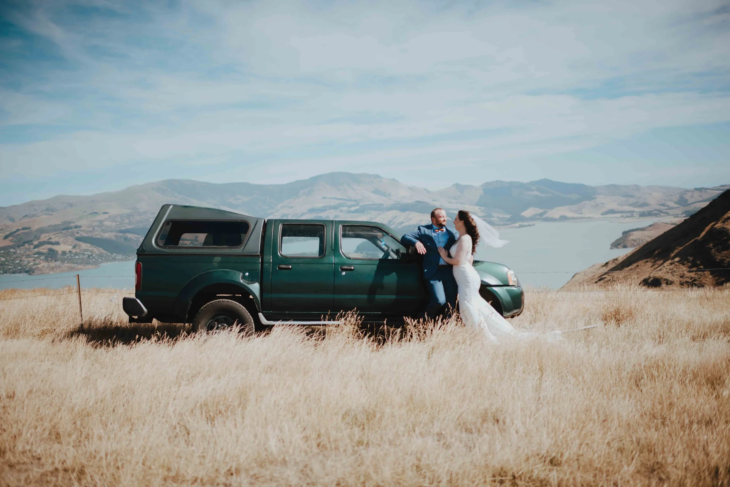 couple overlooking governors bay with their trusted 4wd couple overlooking governors bay with their trusted 4wd