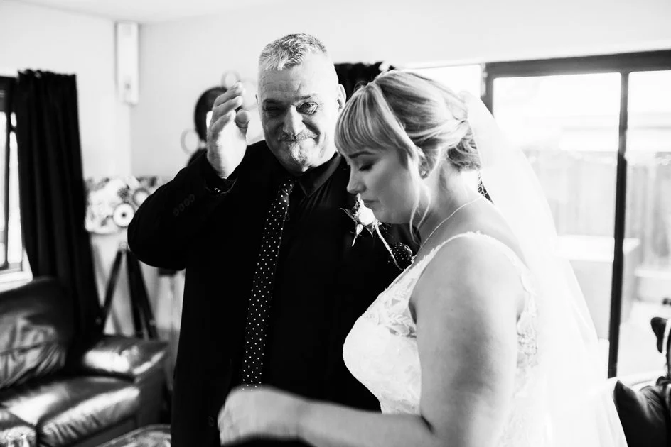 father crying after seeing his daughter dressed up and ready for her wedding