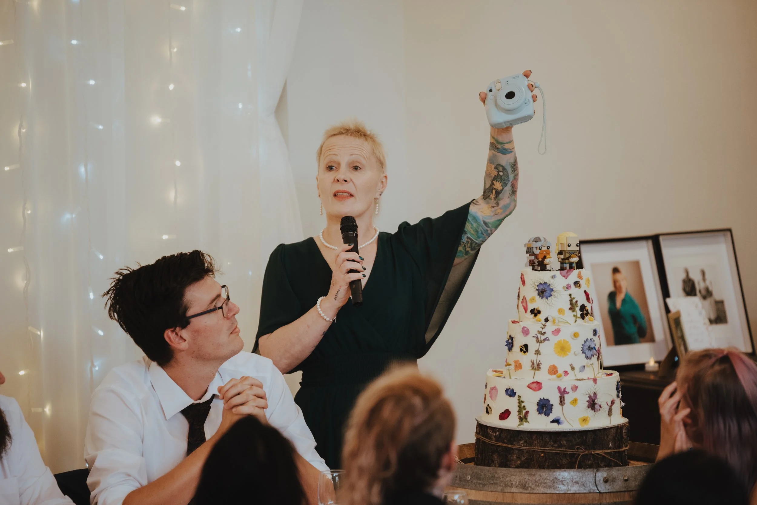 Emcee (or MC) making a joke about technology while introducing the Instant Photo packs available to guests.