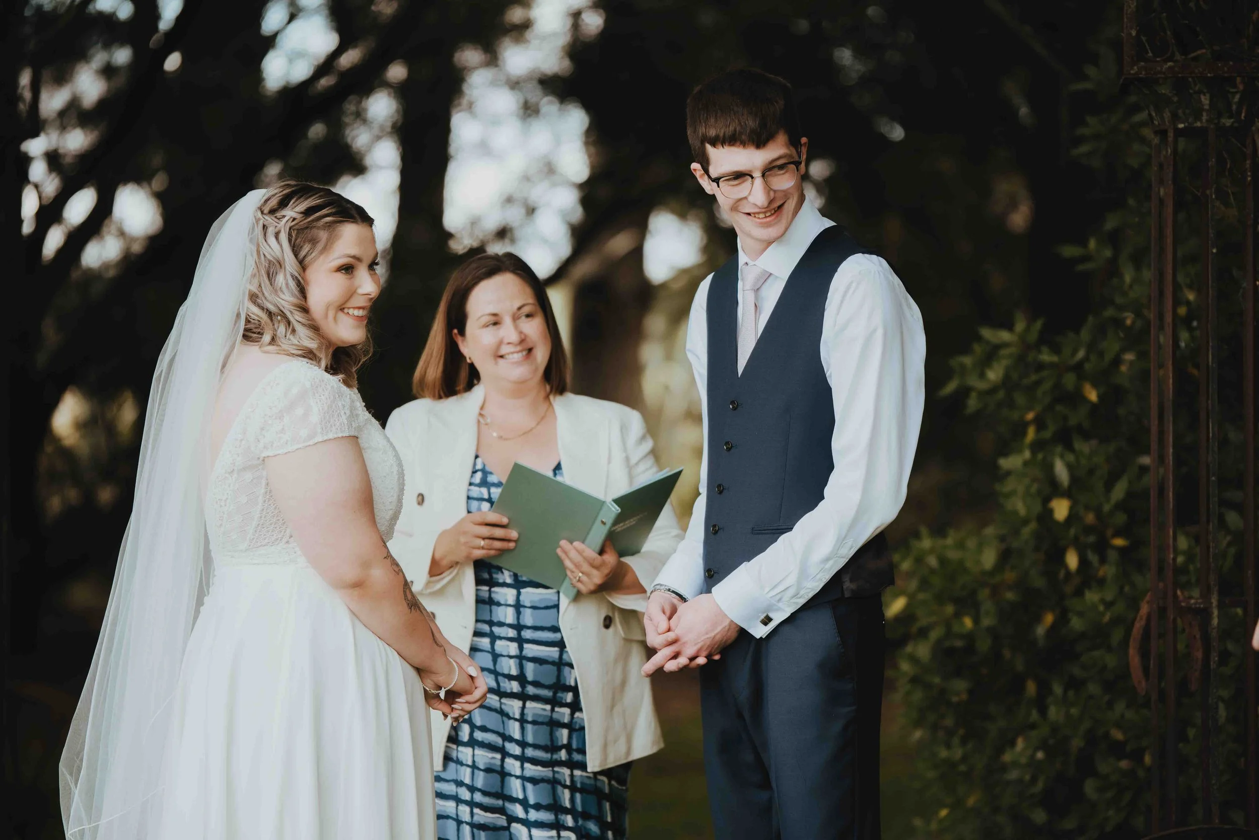 couple during their wedding ceremony looking to guests couple during their wedding ceremony looking to guests