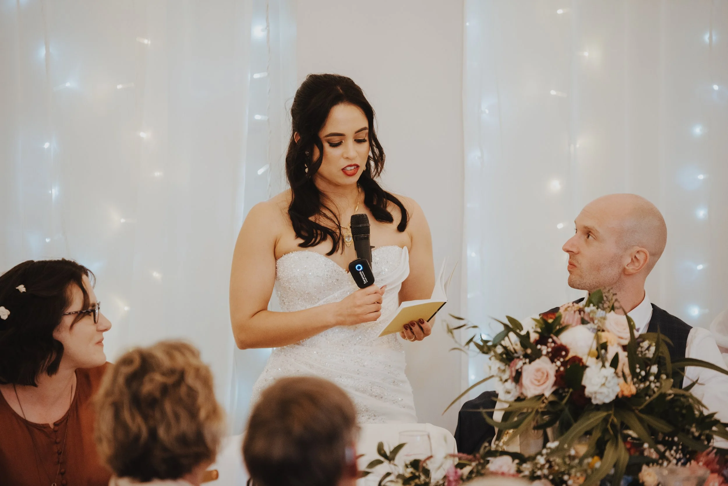 Bride giving a speech on behalf of herself and her new husband