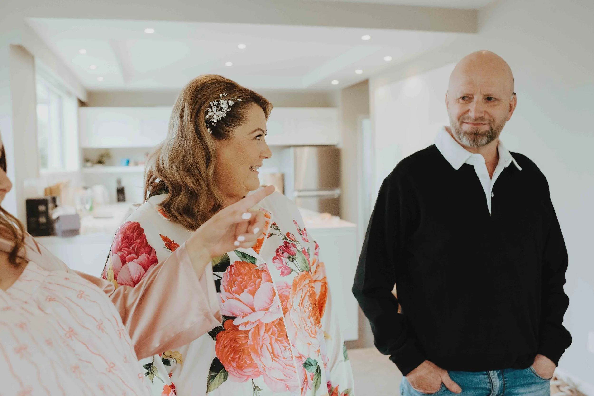 mother of the bride smiling at her husband while he's trying not to cry mother of the bride smiling at her husband while he's trying not to cry