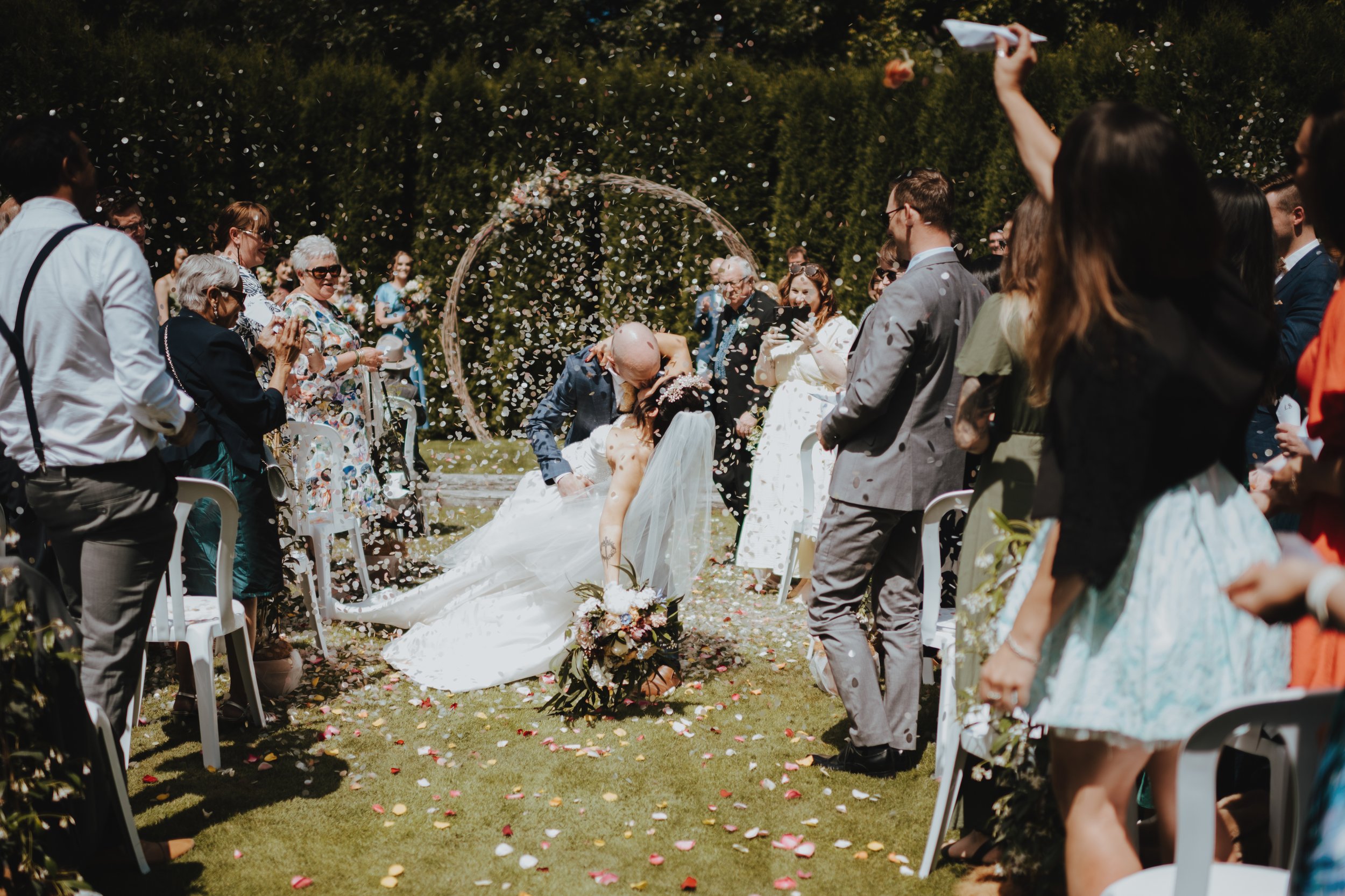 confetti being thrown over newlyweds confetti being thrown over newlyweds
