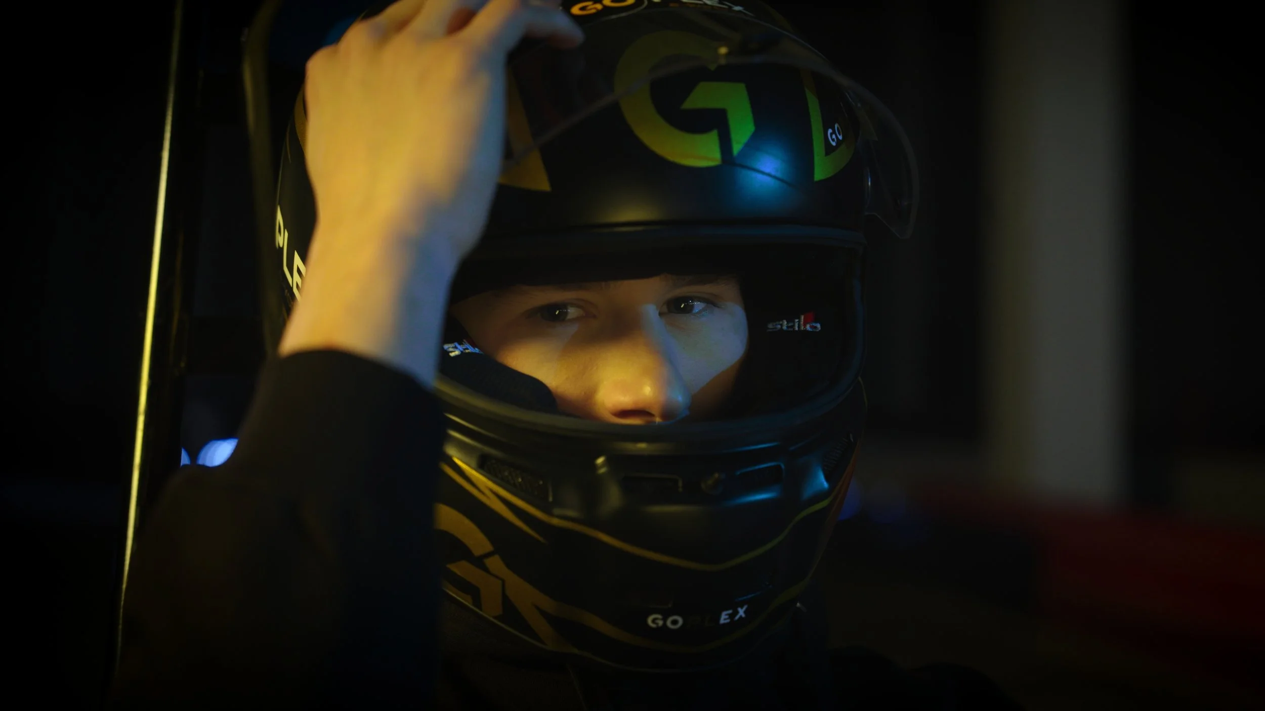 Ivan Demidov closing the visor on his go-karting helmet.