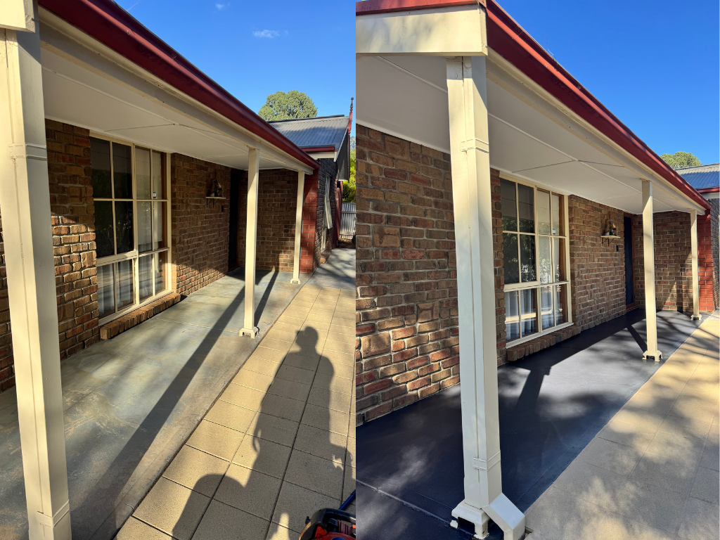 Side-by-side comparison of a porch before and after renovation. The left image shows an older, concrete and tile porch with visible dirt and wear. The right image shows the same porch with a fresh black coating, cleaner appearance, and updated look. Both images feature a brick house with a large window and white support columns, under a red roof edge. Shadows of nearby objects are cast on the porch surfaces.