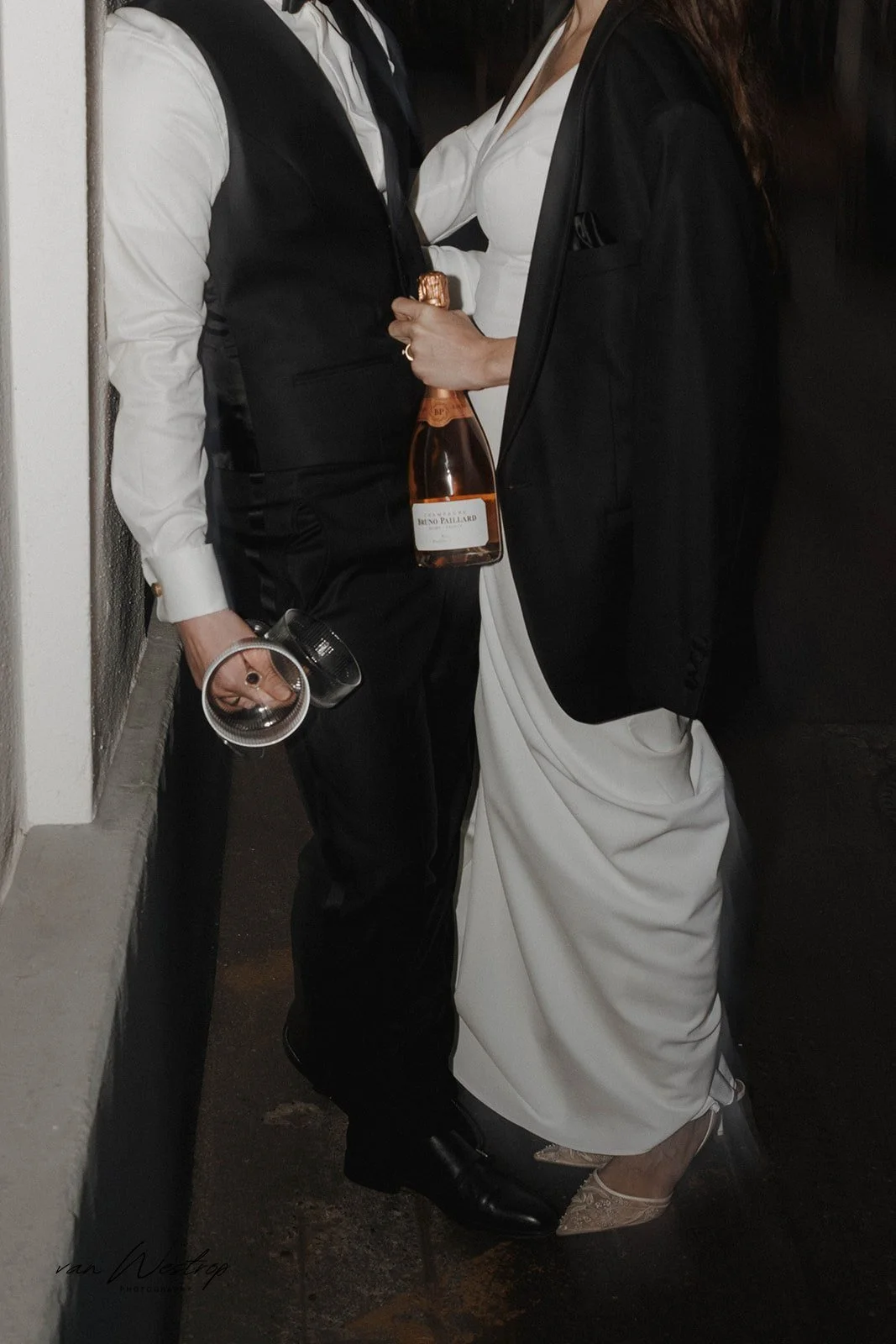 Brautpaar hält nach ihrem Hochzeitstag in Mainz eine Flasche und Gläser in den Händen – festgehalten vom Bart van Westrop, Hochzeitsfotograf in Mainz