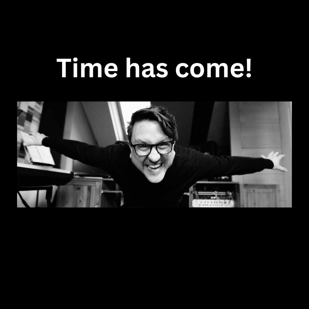 Black and white image of a smiling man with outstretched arms, wearing glasses, in an indoor setting with text "Time has come!" above.
