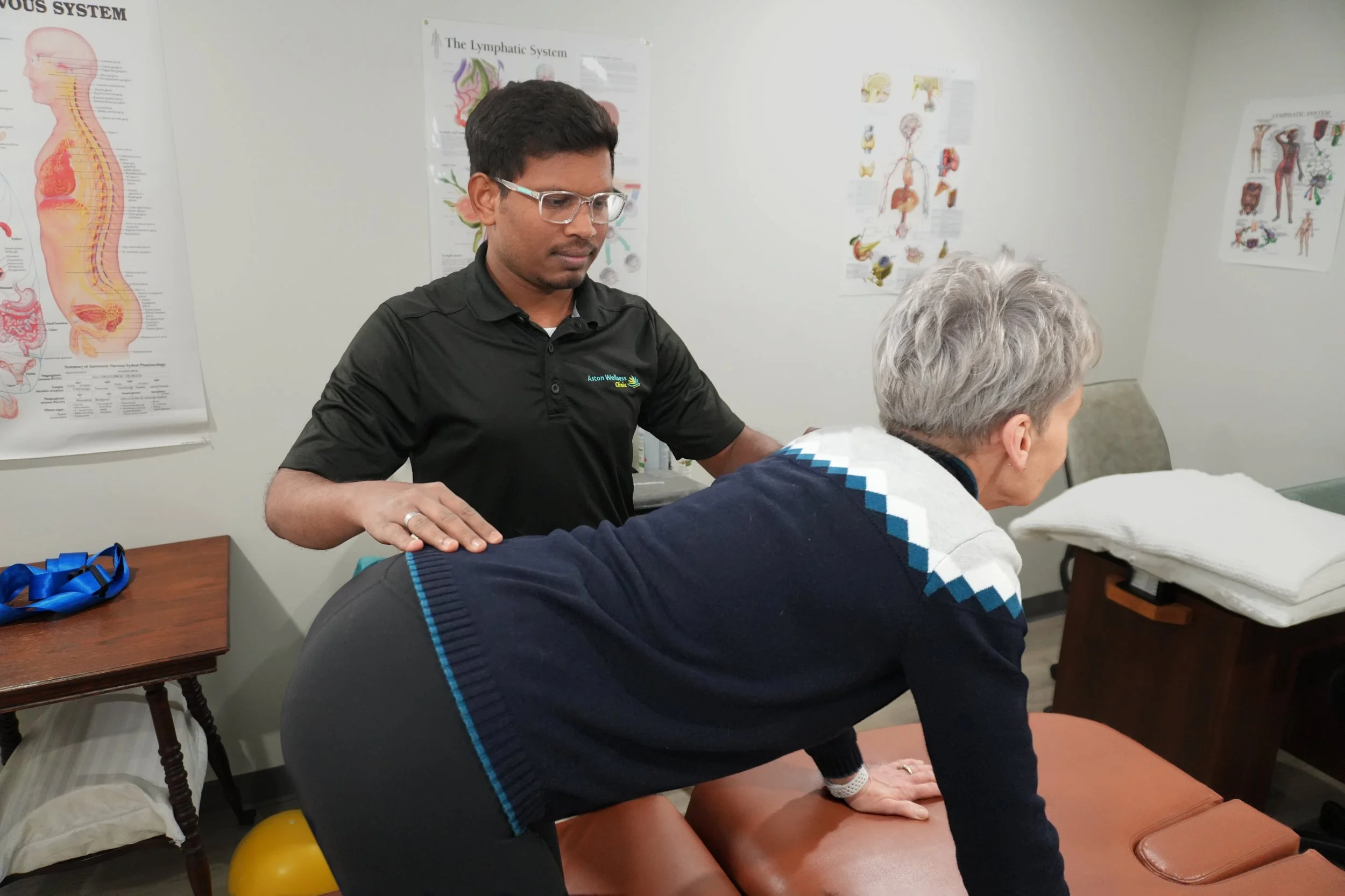 Deepesh guiding a client through a stretching routine.