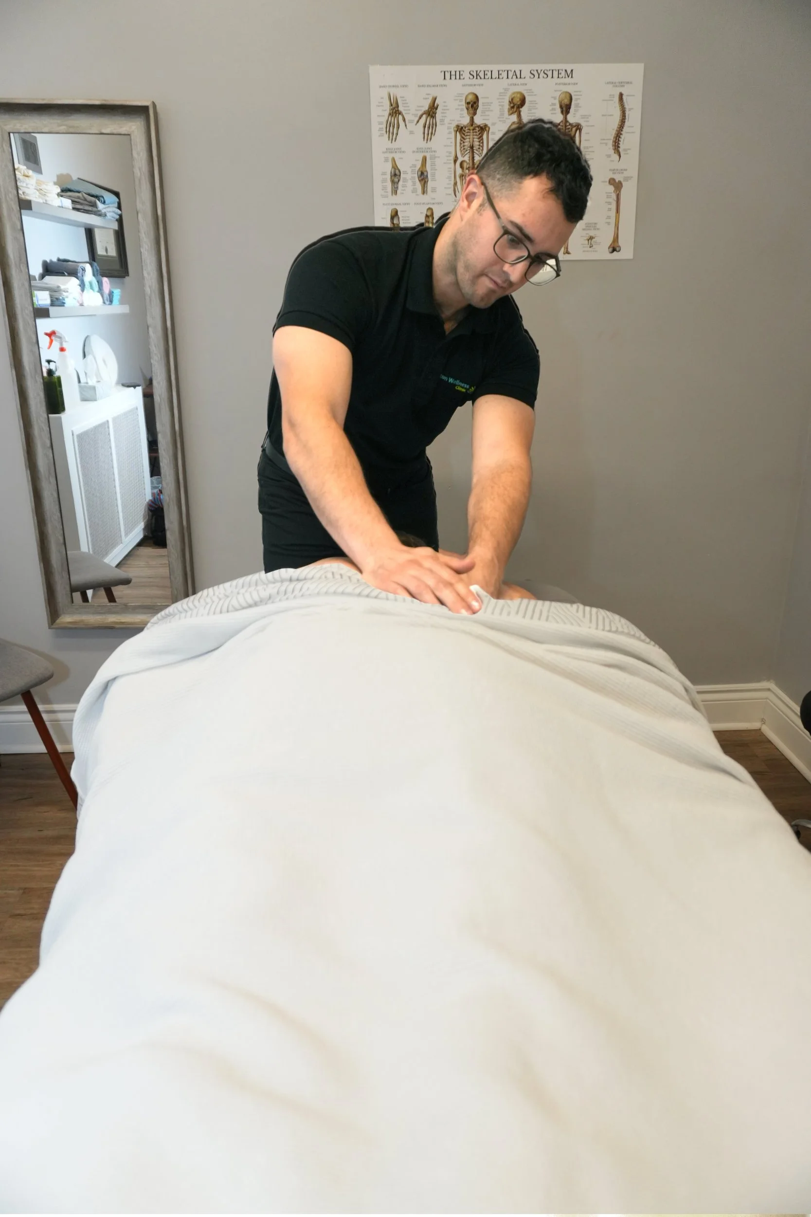 Manuel Gil massaging a client at Aston Wellness Clinic.