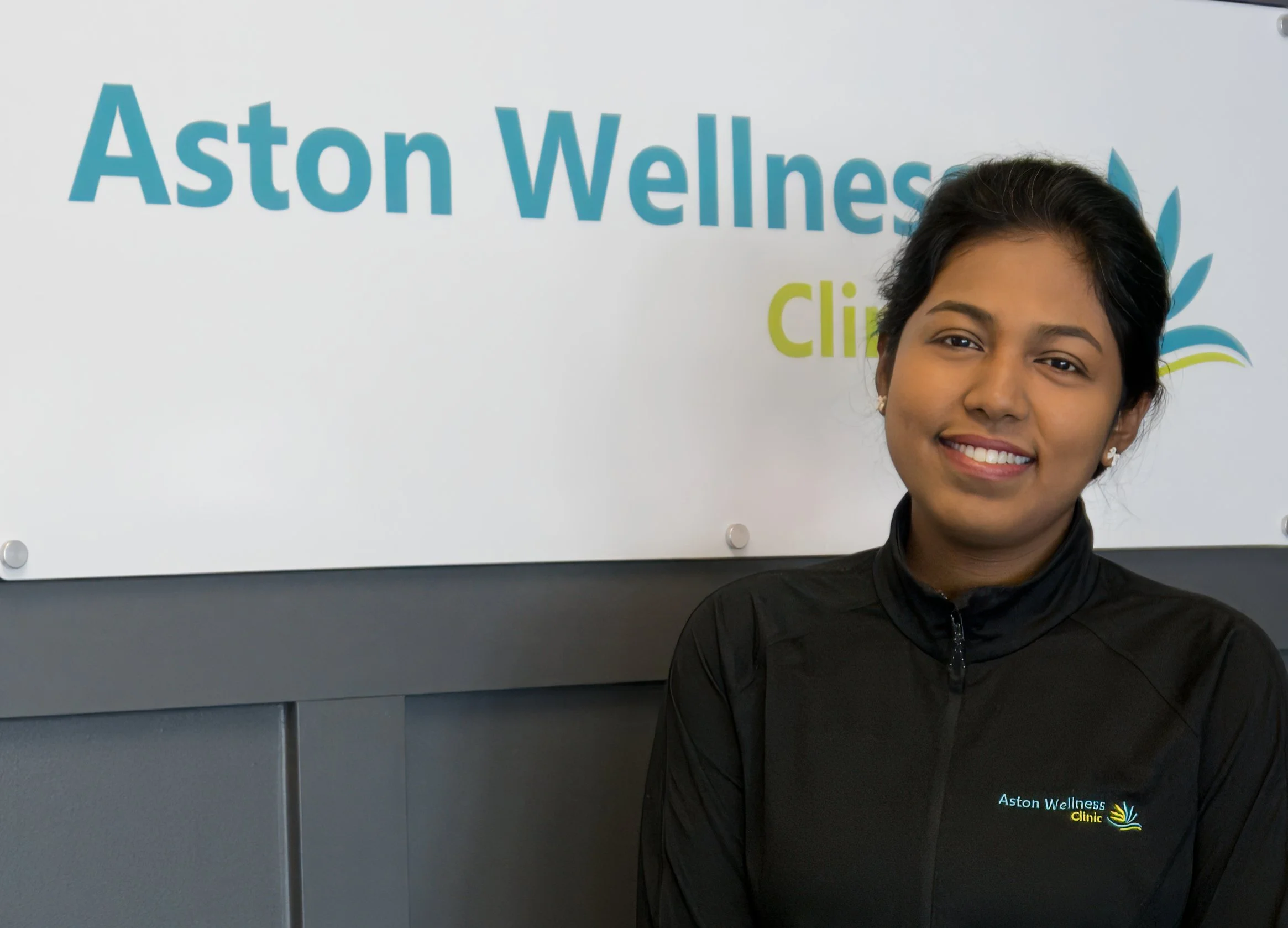 Lady France posed in front of the Aston Wellness Clinic sign