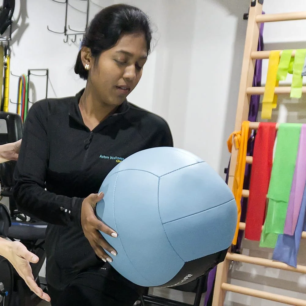 Lady doing a flexibility exercise with a ball.