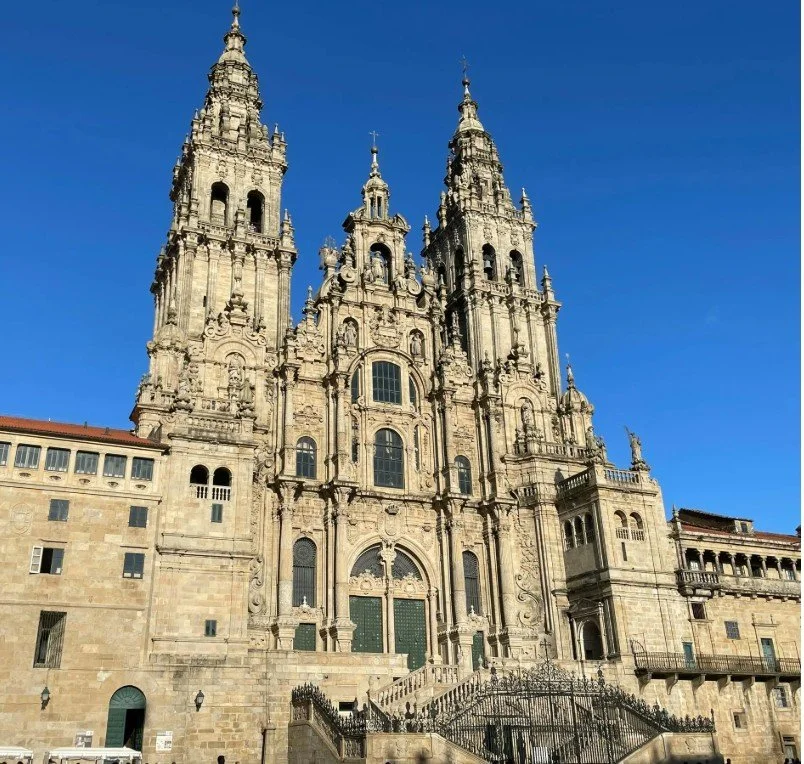 Baroque-style cathedral with twin towers and ornate facade against a clear blue sky.