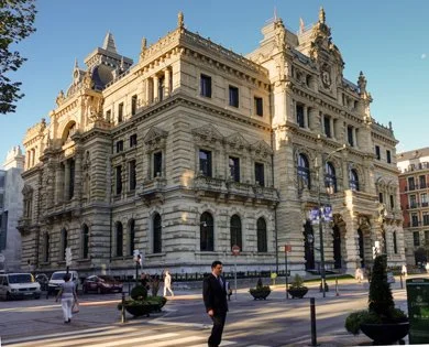 Historic ornate government or institutional building with classical architecture, decorative carvings, and multiple stories in an urban setting.