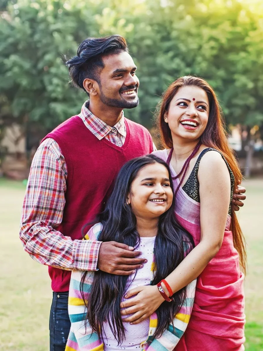 Young family wearing matching colours at a park