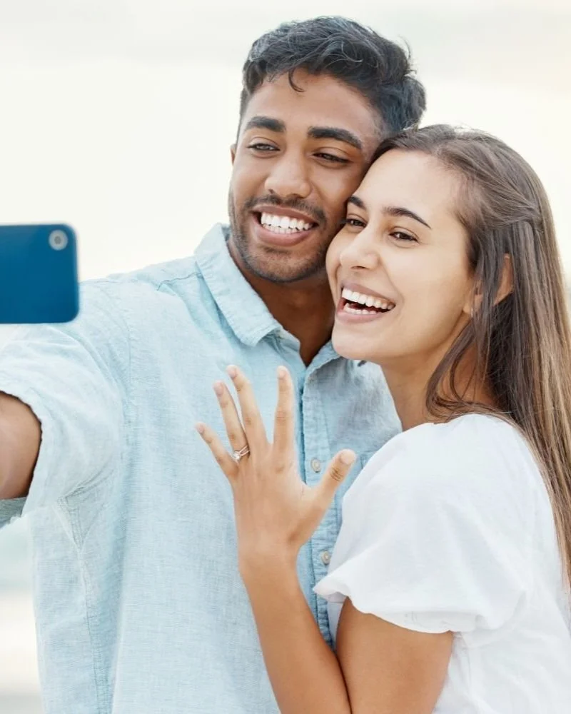 Newly engaged young couple taking a selfie