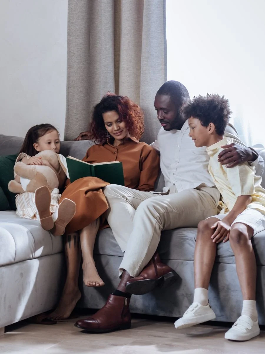 Mixed racial family reading a book together
