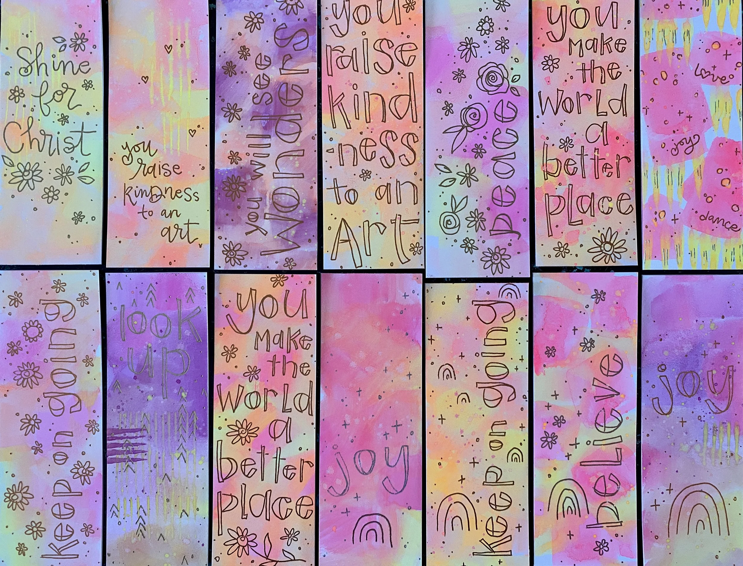 Colorful, pastel-painted background with handwritten inspirational quotes and floral doodles, arranged in vertical strips. Quotes include 'Shine for Christ,' 'you raise kindness to an art,' 'you will rise victorious,' 'you raise kindness to an art,' 