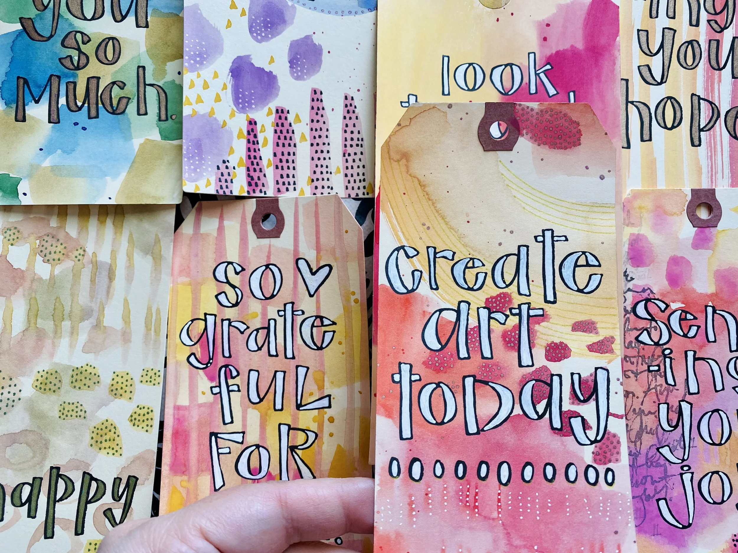 Collection of colorful watercolor bookmarks with inspirational quotes and decorative patterns.