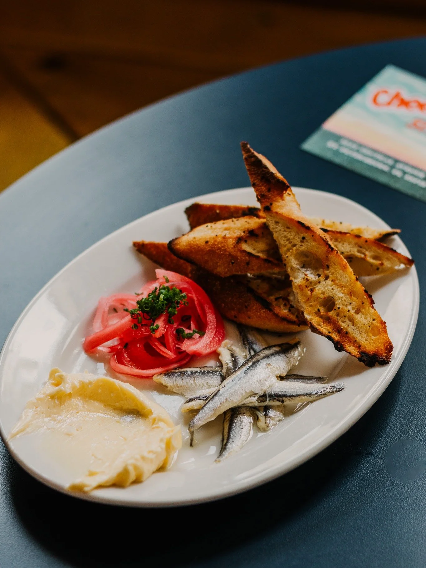 Cheeky&rsquo;s Anchovy Toast with whipped butter and pickled onions and really good grilled bread.