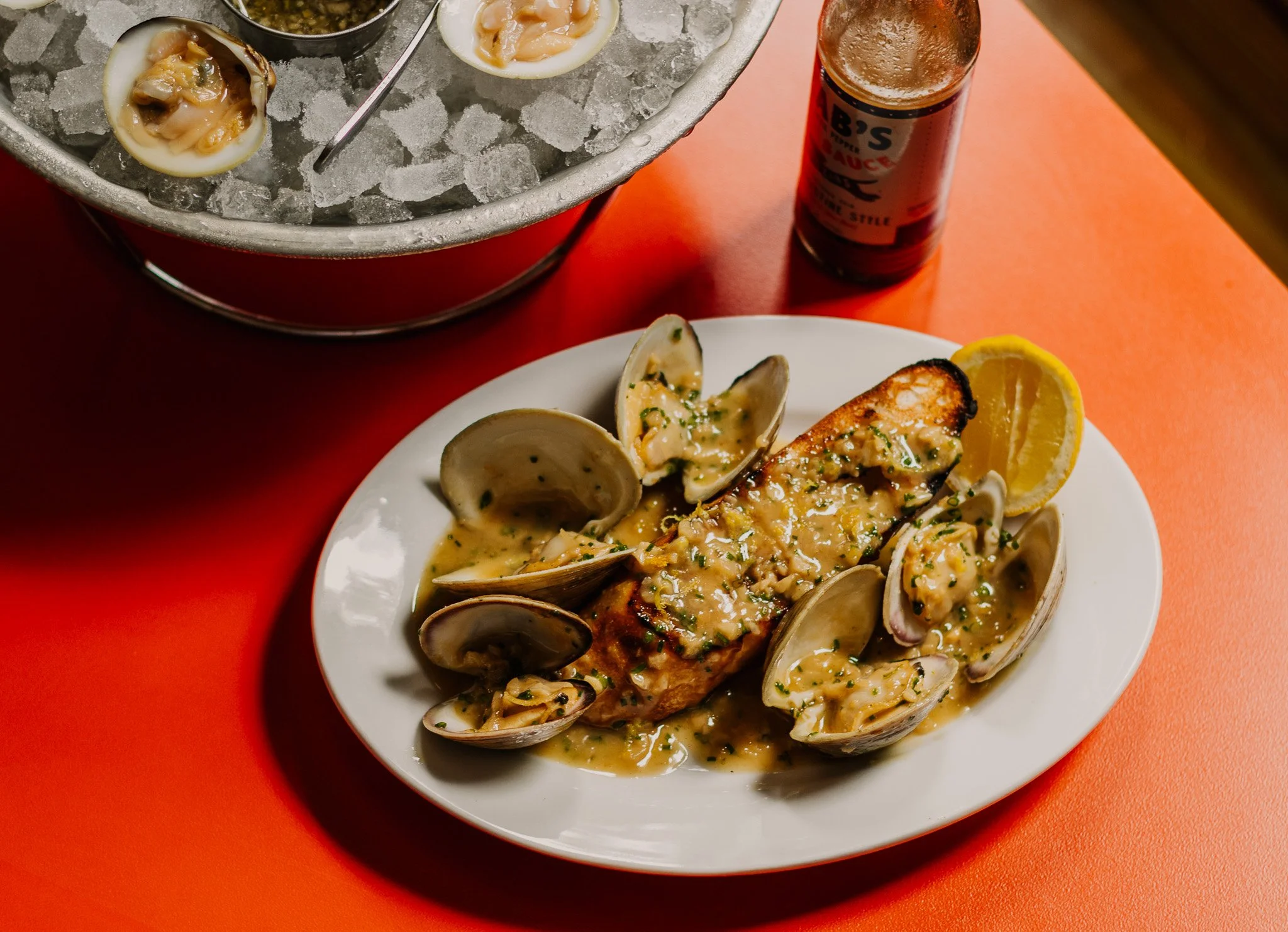 Clam toast with grilled baguette and lemon butter sauce