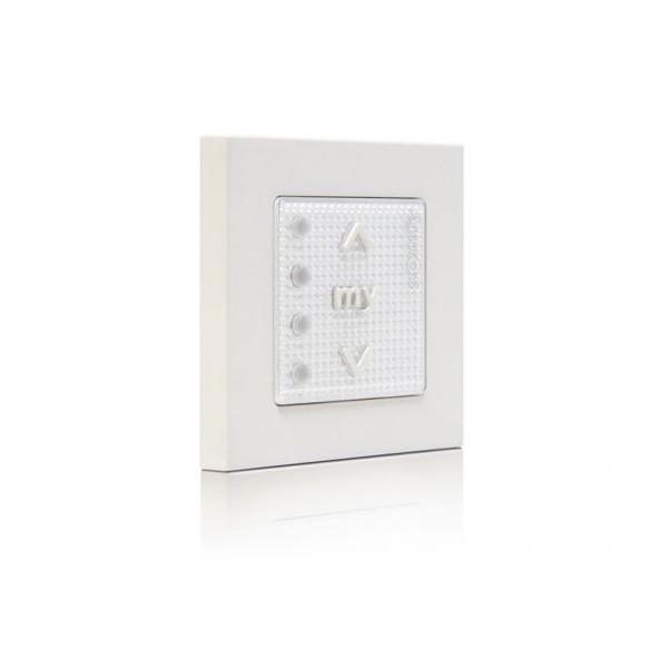 Wall-mounted remote control with buttons for raising, lowering, and a central "my" button, used for controlling blinds or shades.