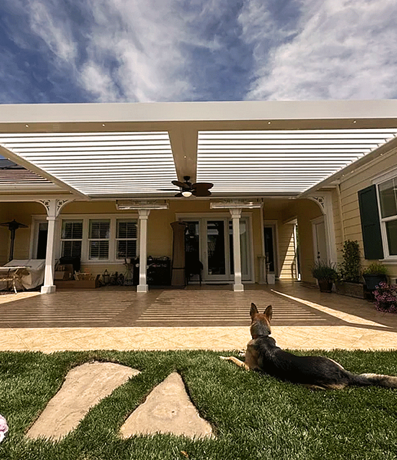 Louvretec 180 Linear louvered roof installed over a patio with white aluminium framing, providing adjustable shade for outdoor living at a residential home.