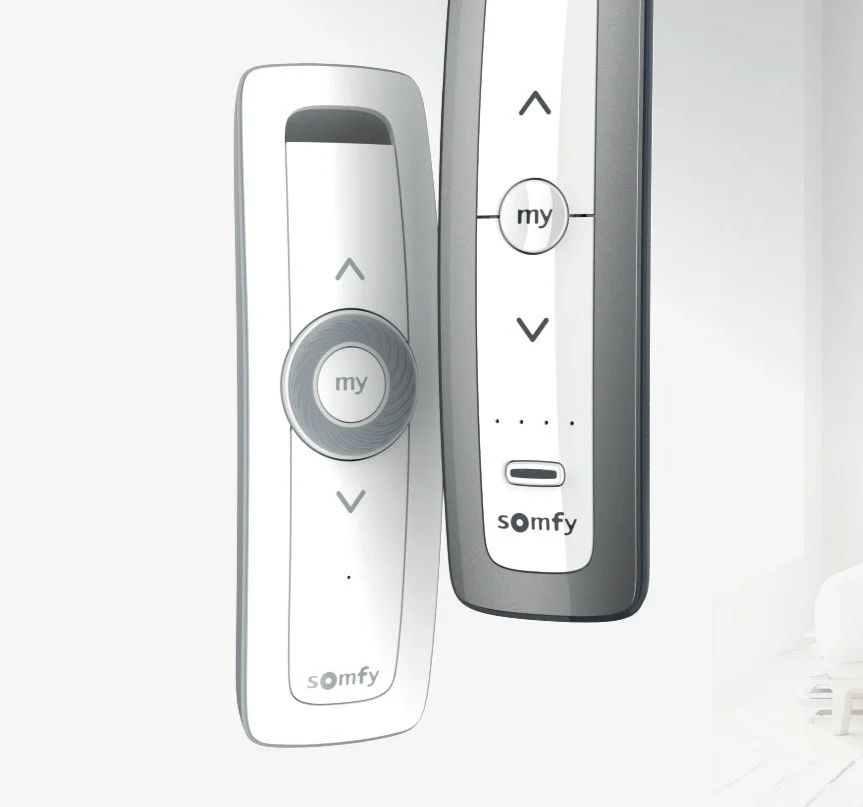 Two remote controls for Somfy motorized blinds, featuring up, down arrows and a central 'my' button.