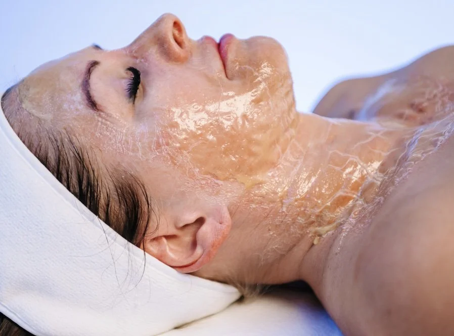 Person receiving a face mask treatment at a spa