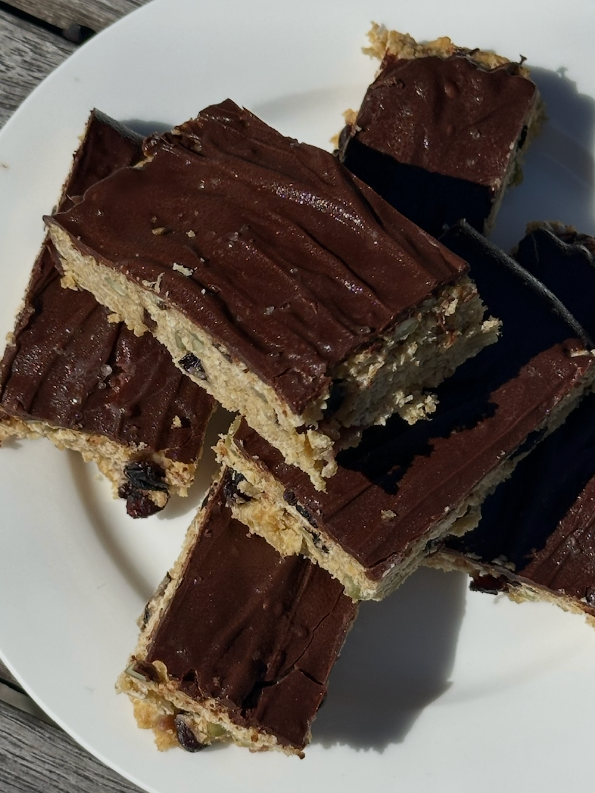 Oat and dark chocolate slice cut into squares — healthy high-fibre snack recipe by Grams of Health dietitians