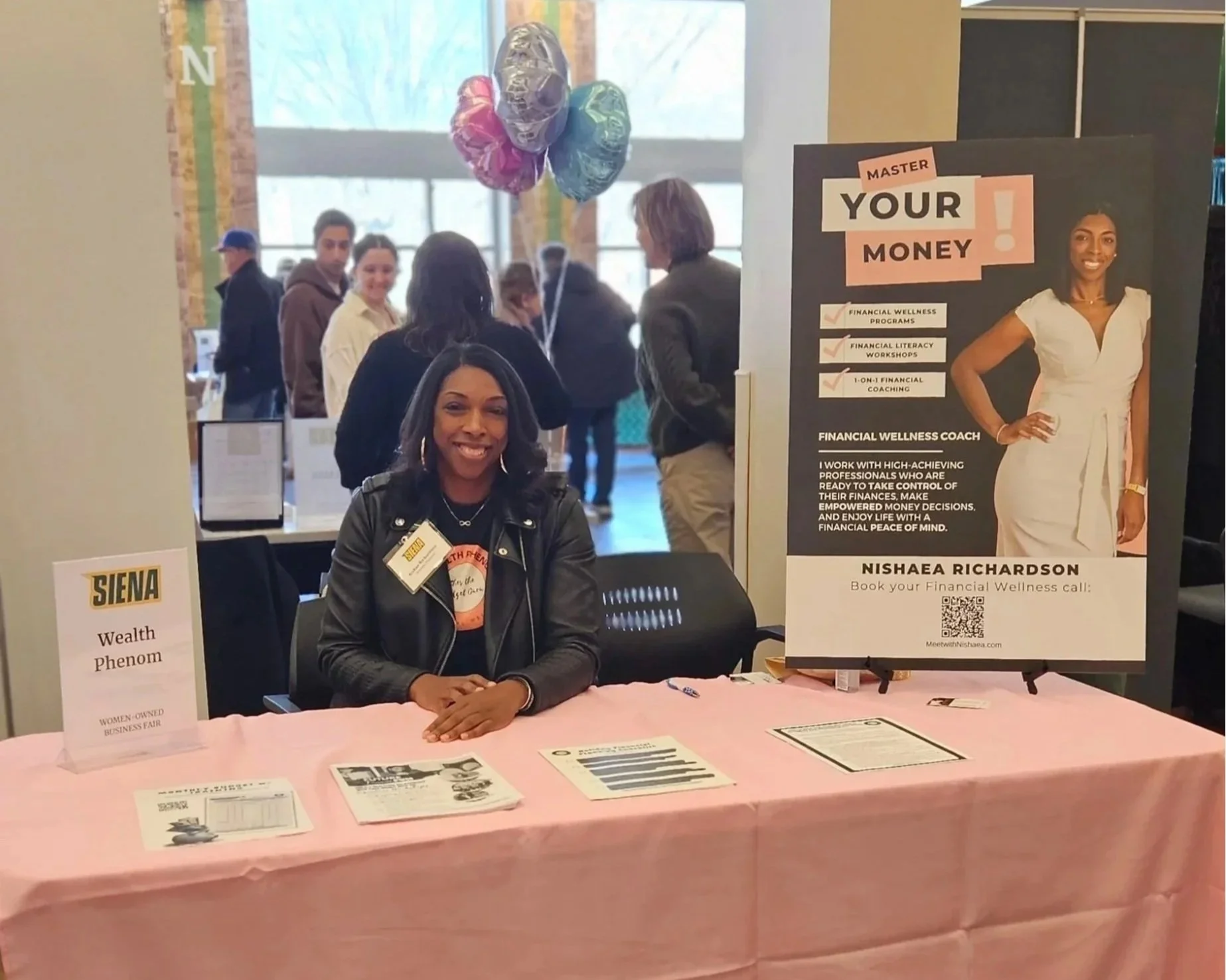 Nishaea Richardson, a financial wellness facilitator, speaking at a community event about building a healthy relationship with money.