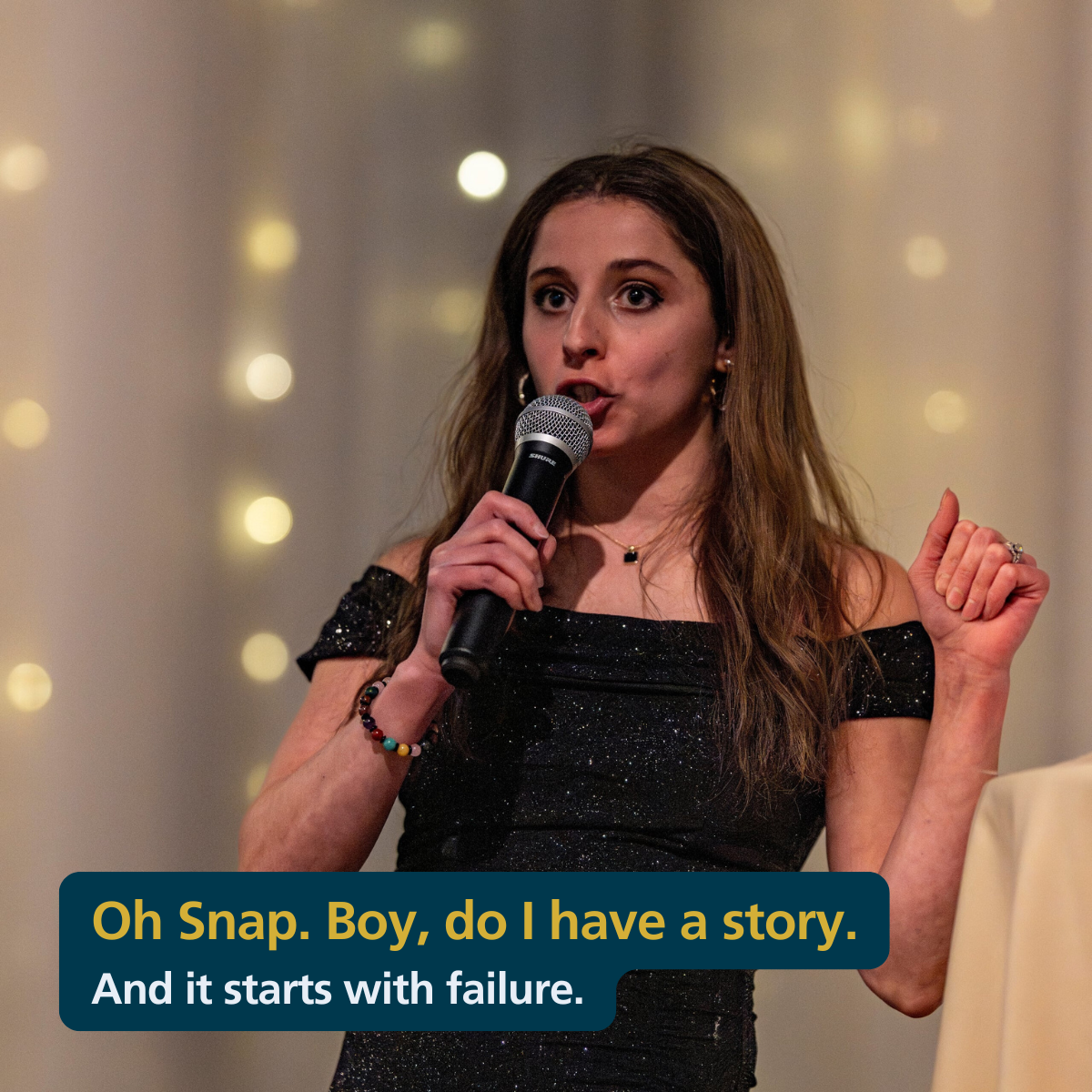 Jen staing on a stage with a microphone, with the caption "Oh Snap boy do i have a story and it starts with failure"