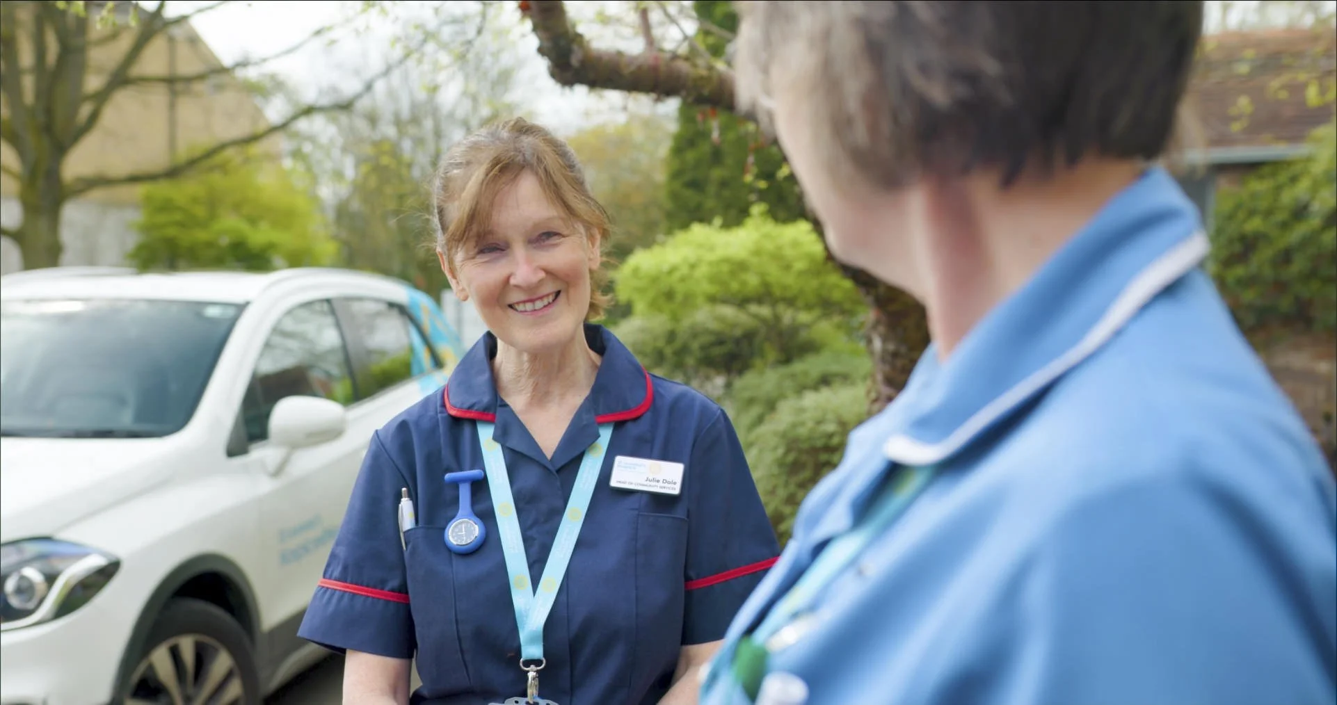 A St Leonards nurse talking to a colleague