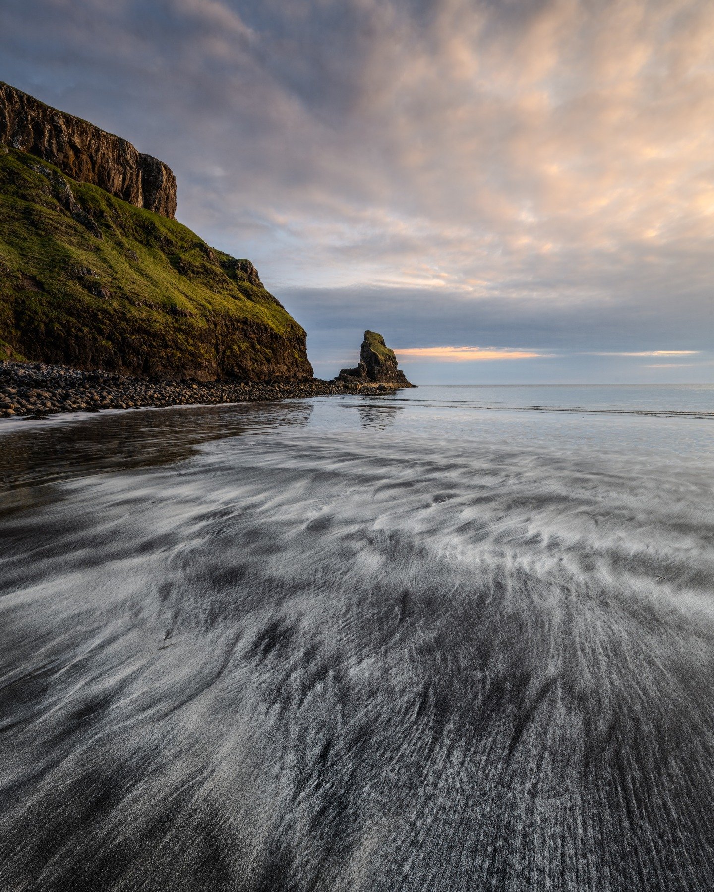 Sunset at Talisker Bay, Scotland 
 The beach here is unique &mdash; the sand is made of two different components, light and dark, mixing together to create beautiful natural patterns. As the waves retreated, they painted the surface with soft lines a