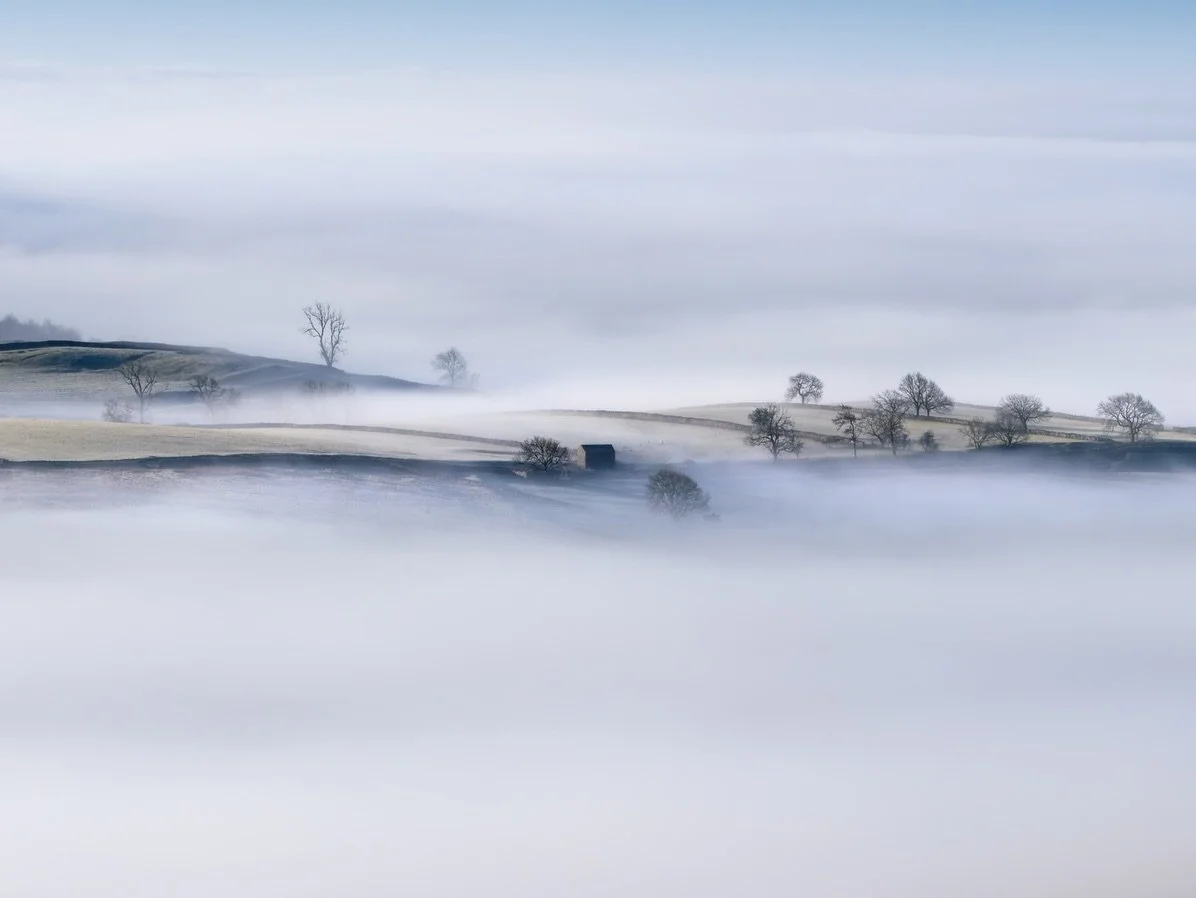 Cloud Inversion Yorkshire Dales.
There are moments in the Yorkshire Dales where the line between photography and painting completely disappears. 
The way the mist wraps around the dry stone walls and lone barns creates an ethereal layer of depth that
