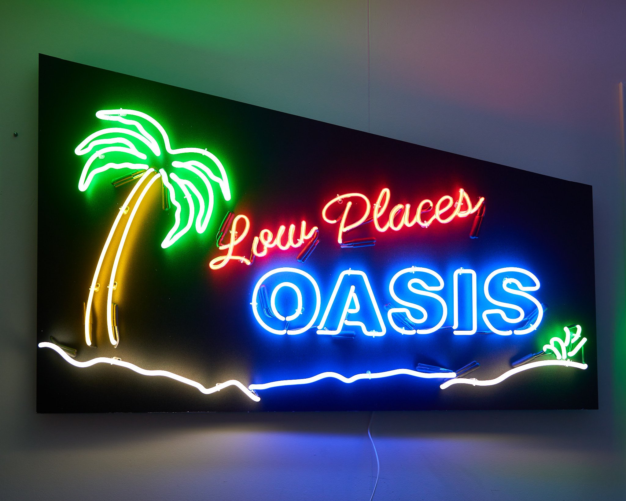 Tina and Tony came to our shop to pick out colors and describe their vision to us for a sign for their recently-compled home bar. They settled on yellow, green, blue and red neon with warm white for the sand, on a custom cut background to match the