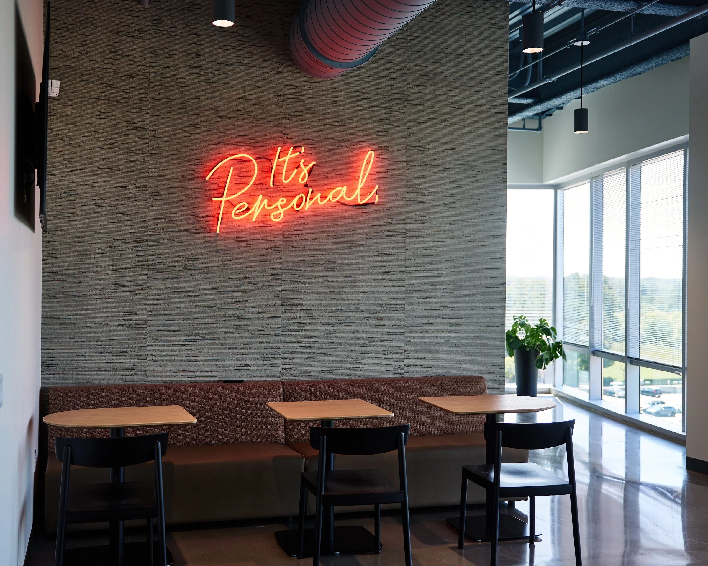 Foundry's new sign is direct mounted on a textured wall in their cafe space, with the power supplies hidden out of view in a small conference room on the opposite wall.