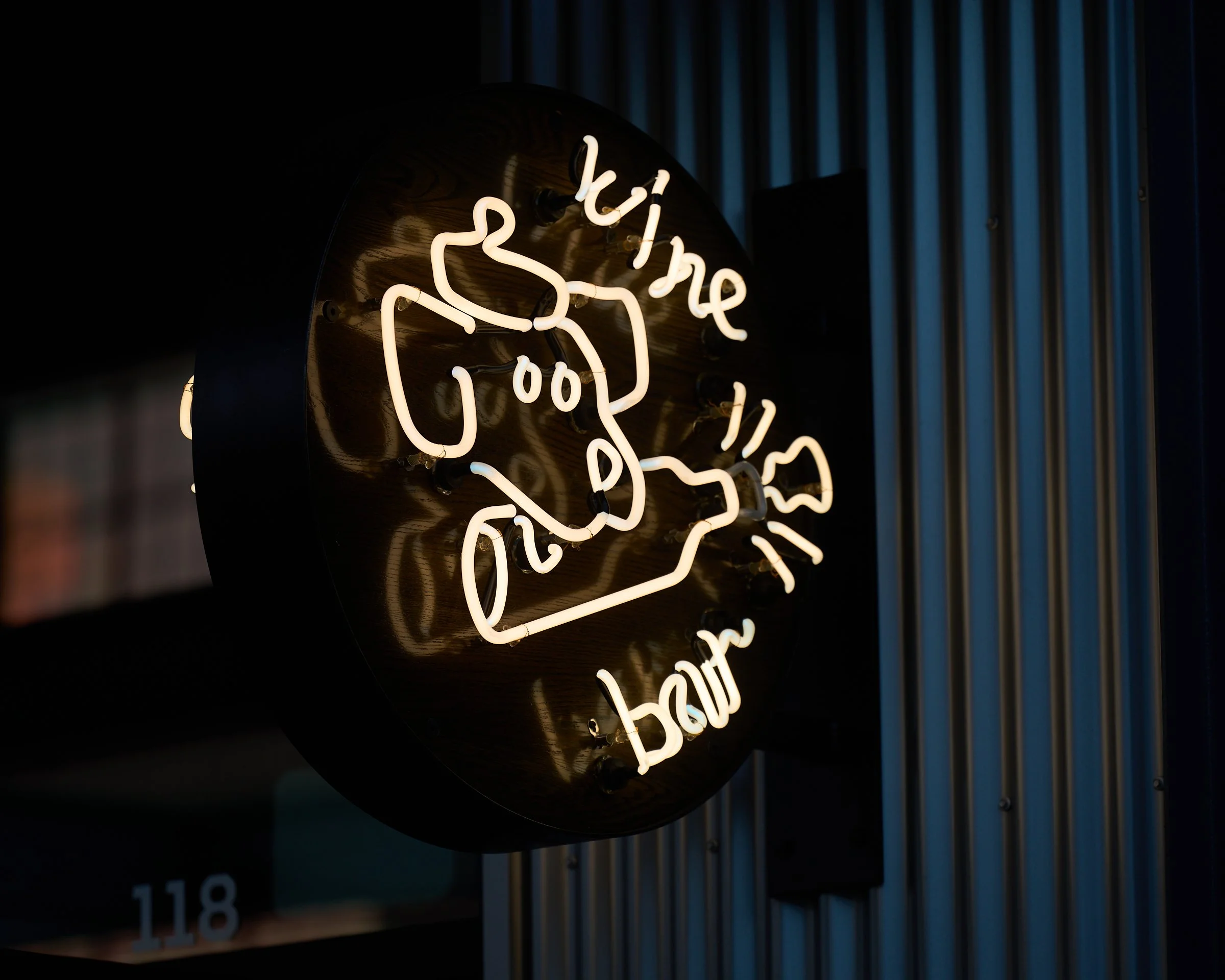 Taking a closer look at the dog, wine bottle, and popping cork on St. Pierre's neon sign.
