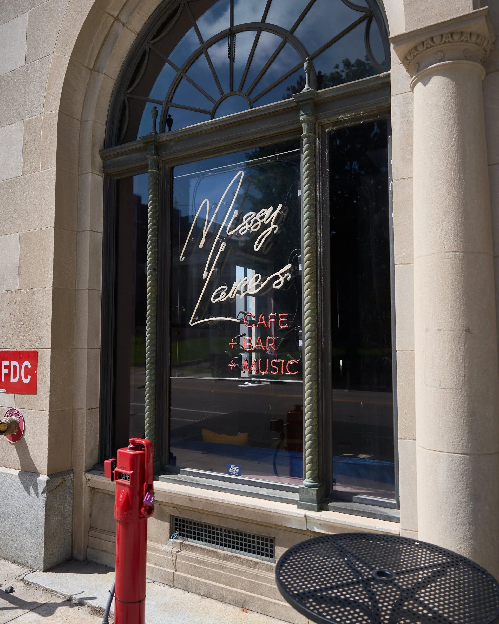 Missy Lane's Assembly Room, with a warm white and clear red neon window sign. The red neon is back-dipped so that it doesn't cast a large amount of red light into their bar area.