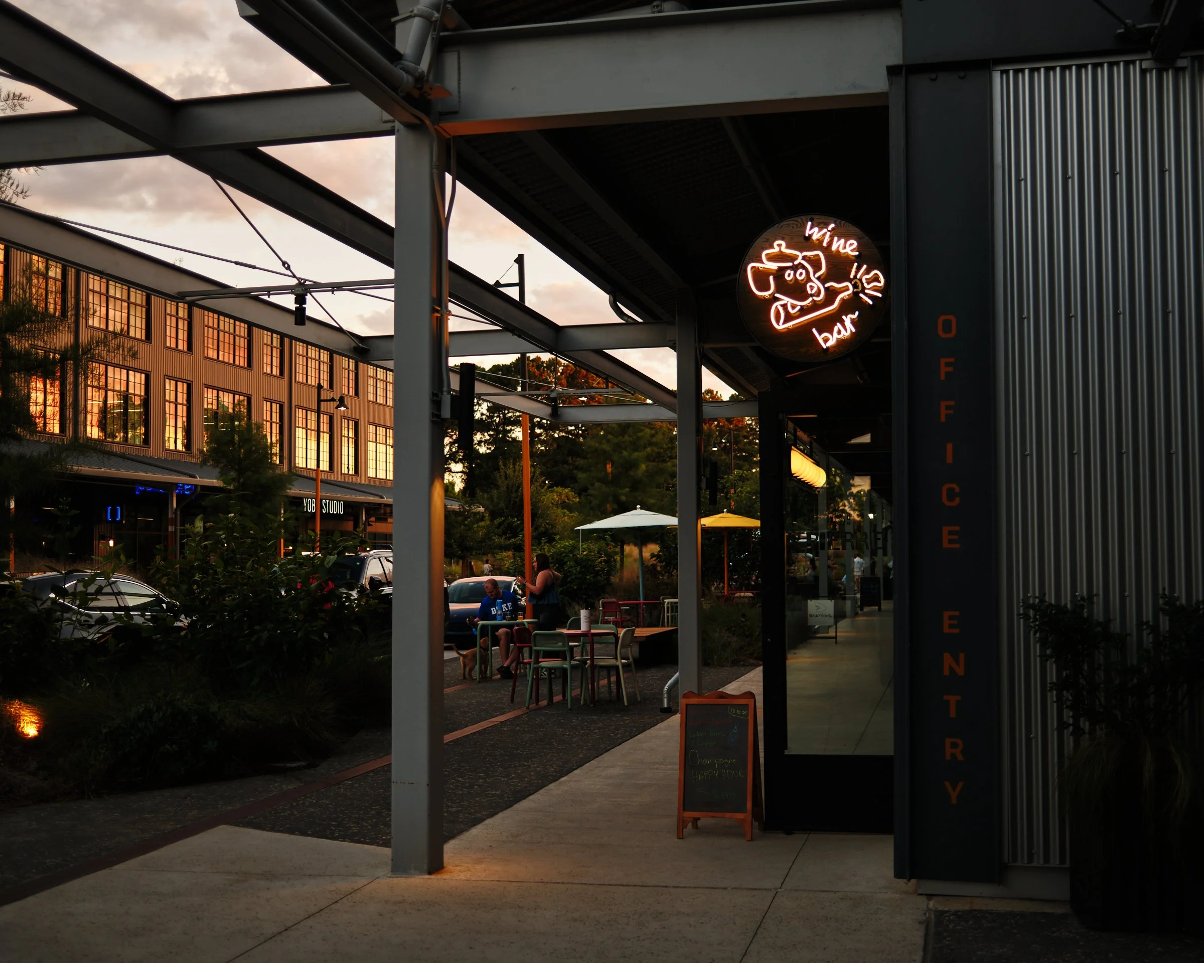 St. Pierre's warm white neon invites visitors to Raleigh Iron Works to stop in for a drink.