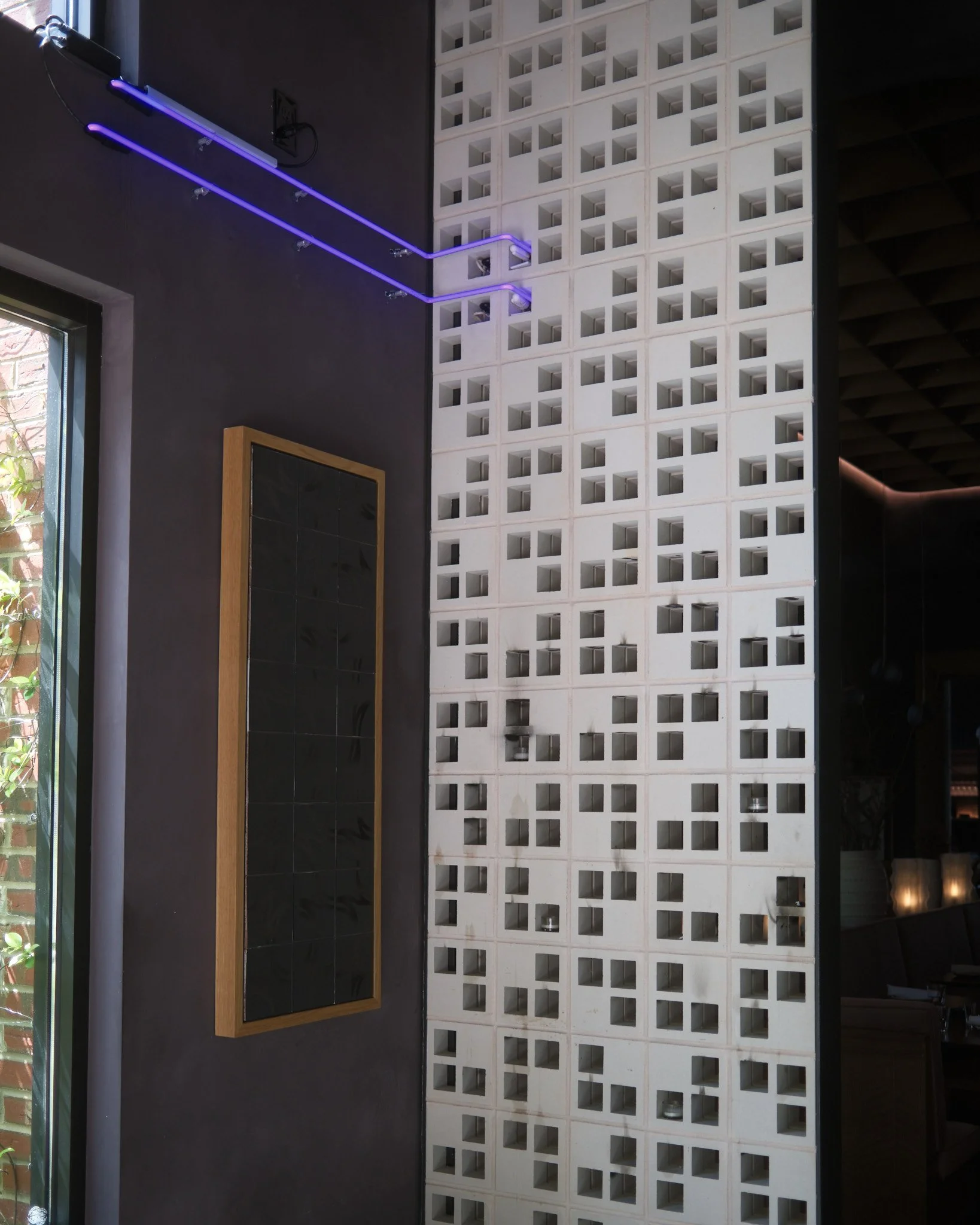Upon entering the foyer of Madre, these purple lines travel across the wall and into the breezeblocks.