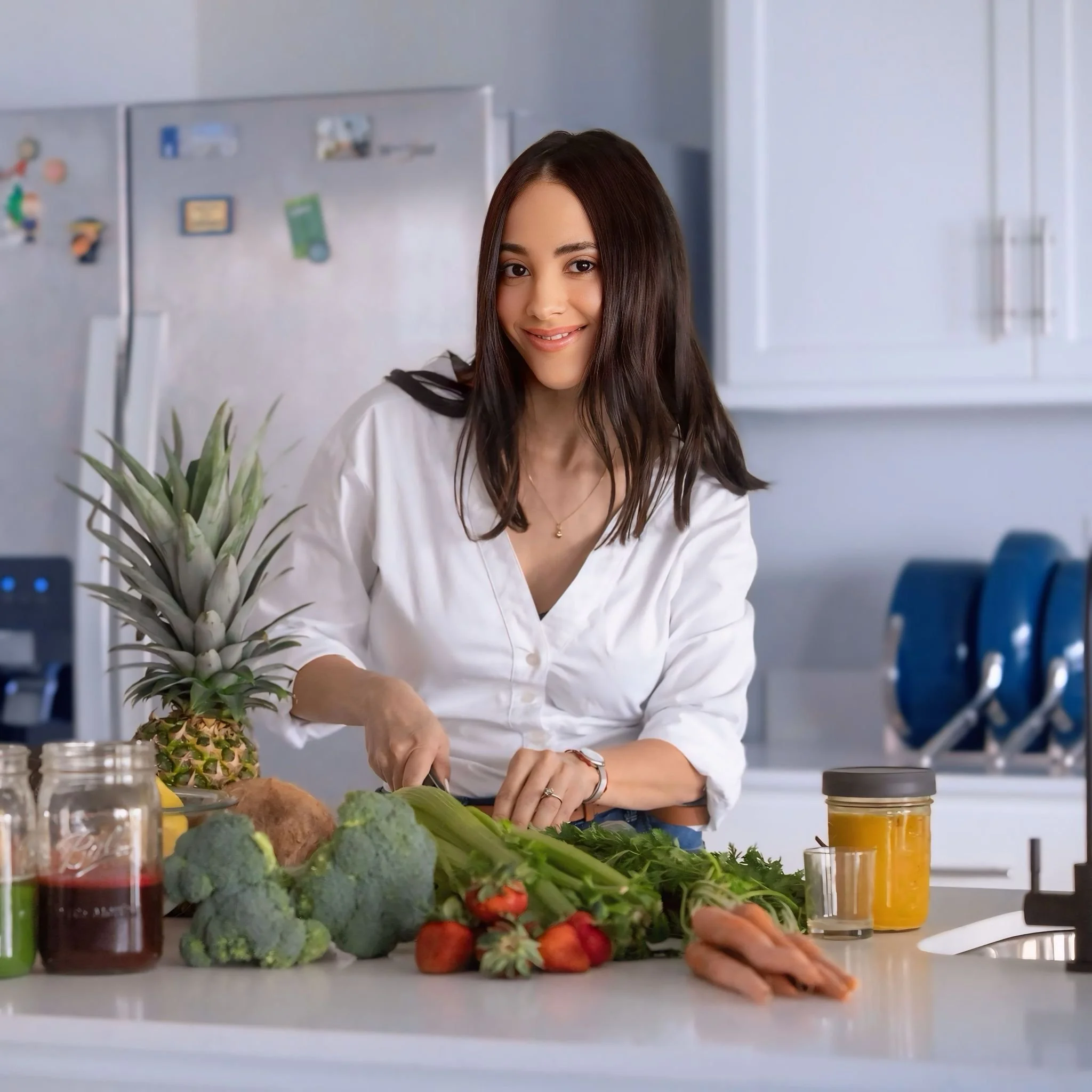 health coach surrounded of fruits and vegetables in a fancy kitchen