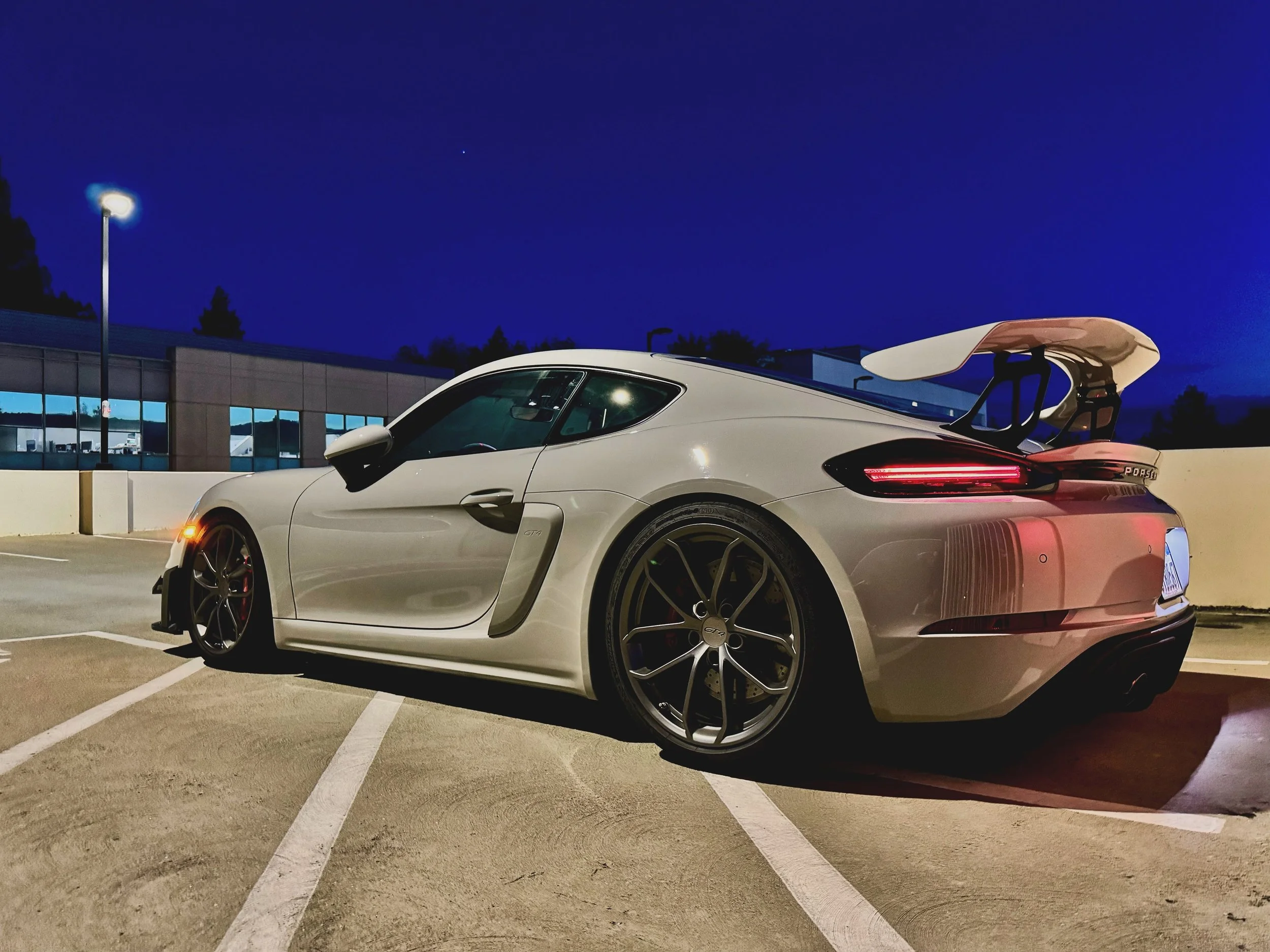 Night image of Chalk Porsche GT4 with RSNV Risers and Blue Spot Autowerks Wing Mounts