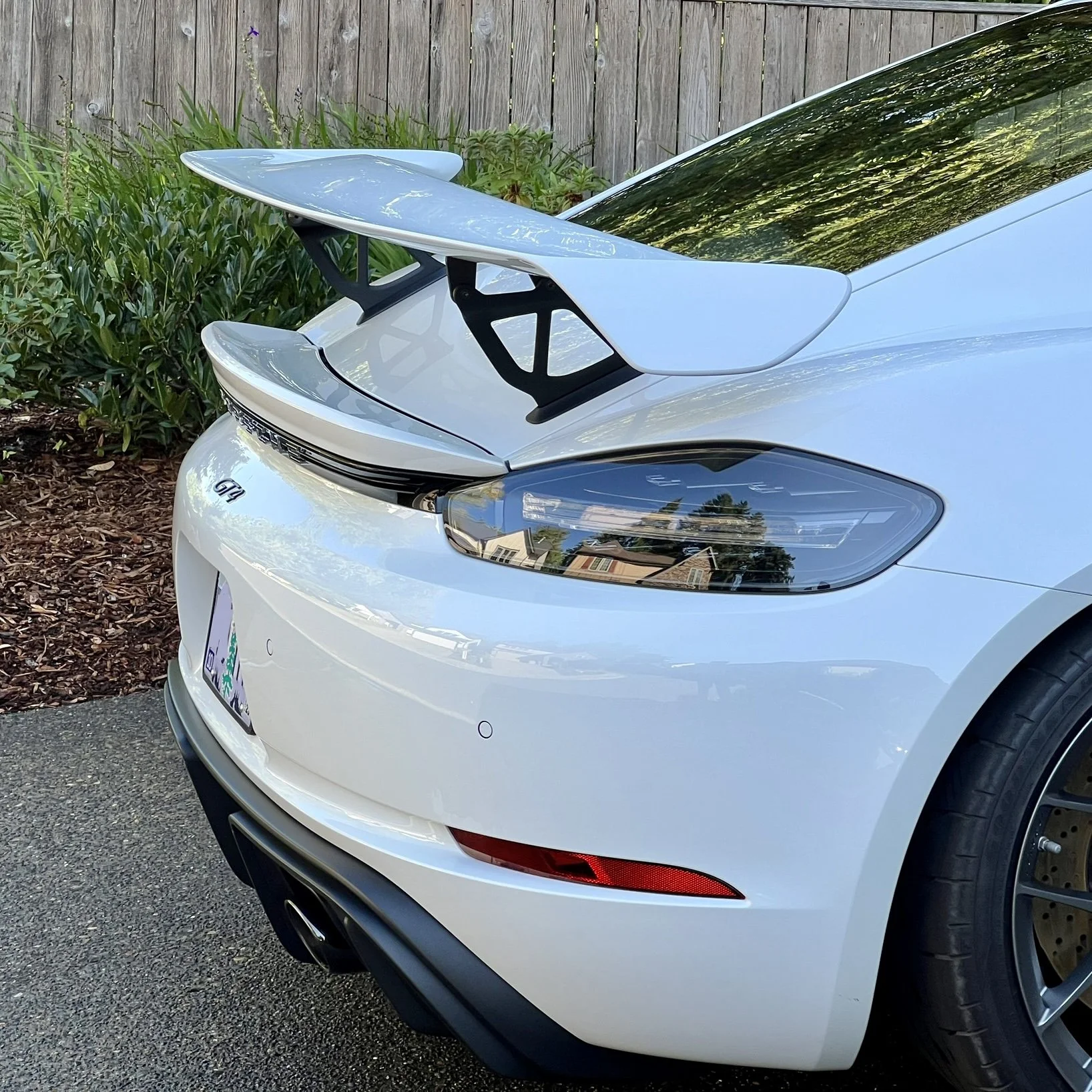 White Porsche GT4 with 718 Cayman GT4 Extra AOA Wing Tall Riser Brackets