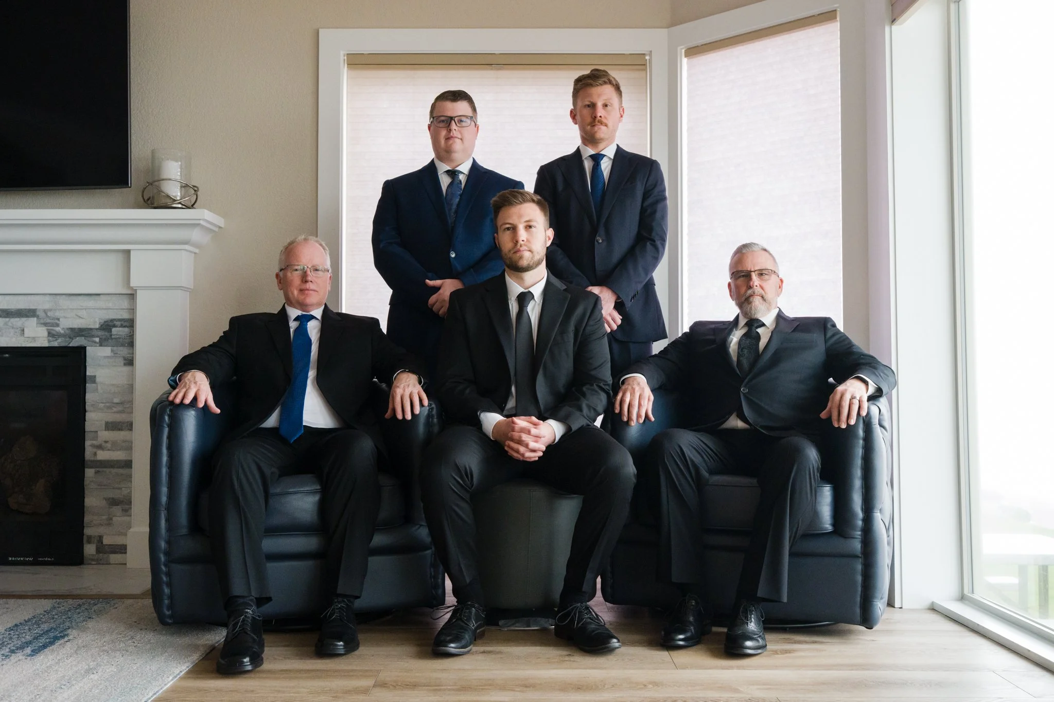 Groom and groomsmen gathered for family portraits during a micro wedding in Lincoln City overlooking Roads End Beach on the Oregon Coast.