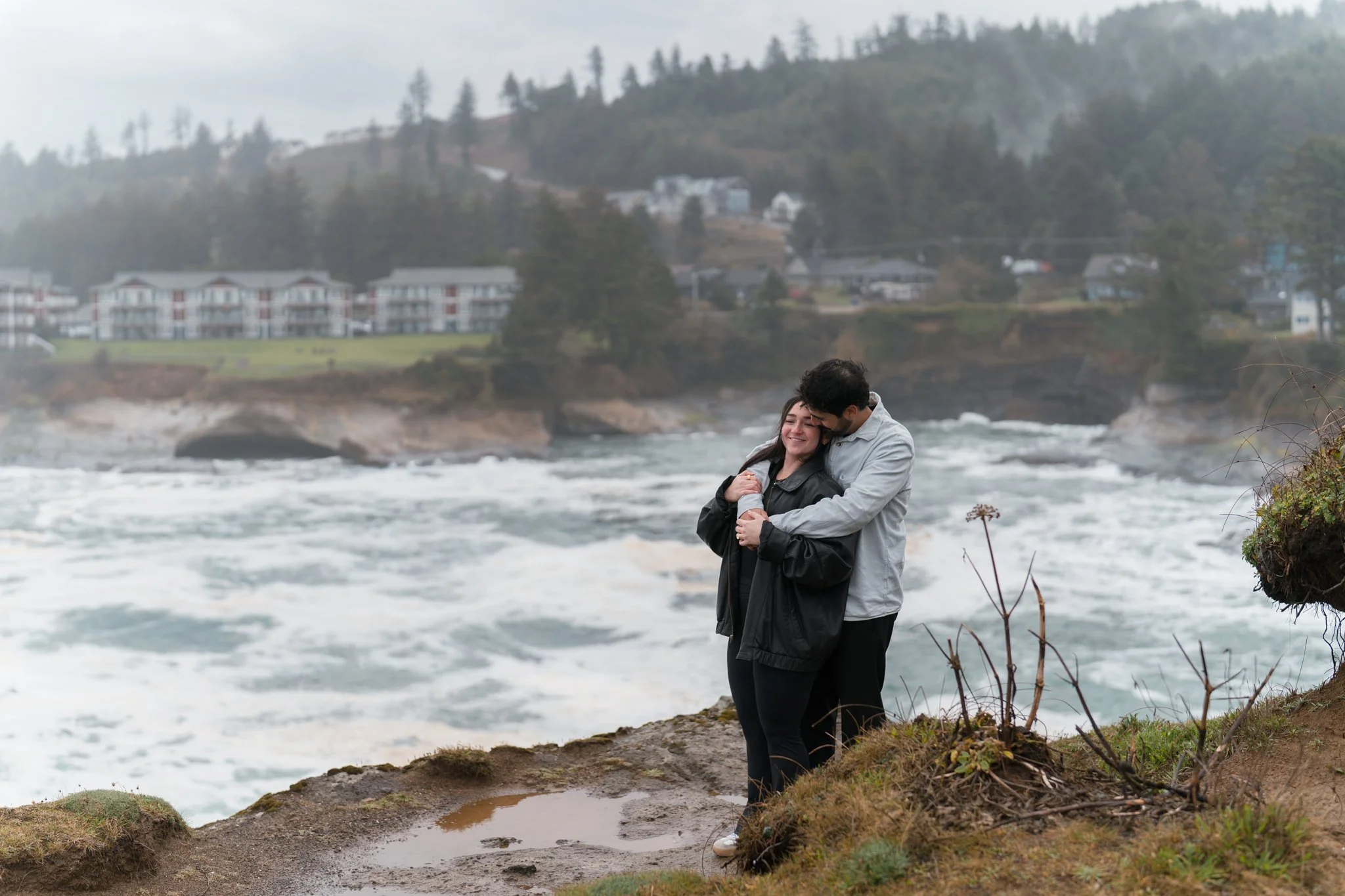 A couple poses by a cliff for their proposal photographer