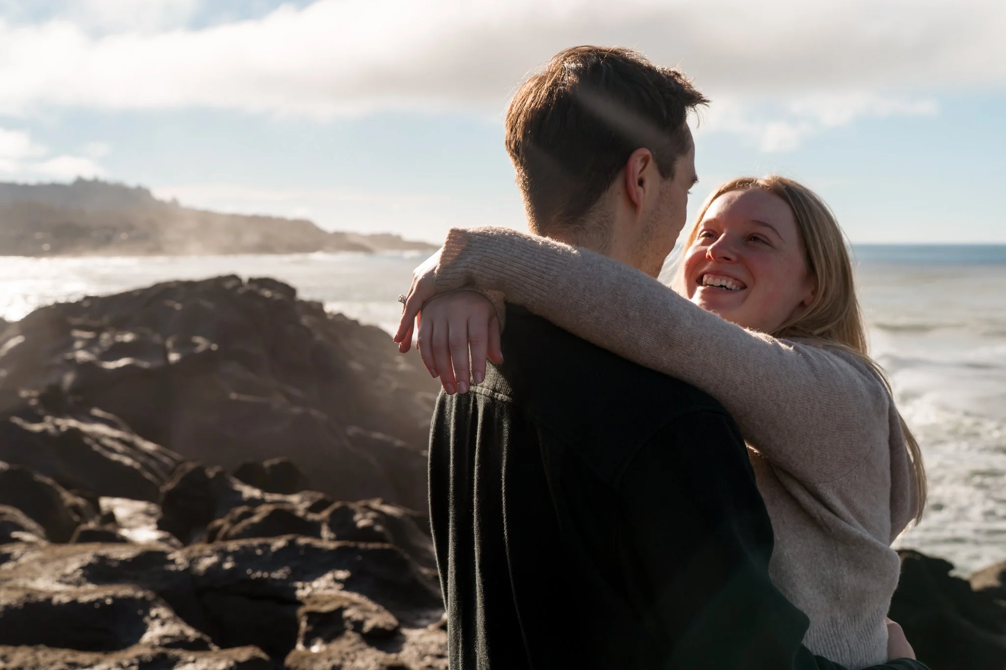 portrait of a recenly engaged couple on the oregon coast in depoe bay