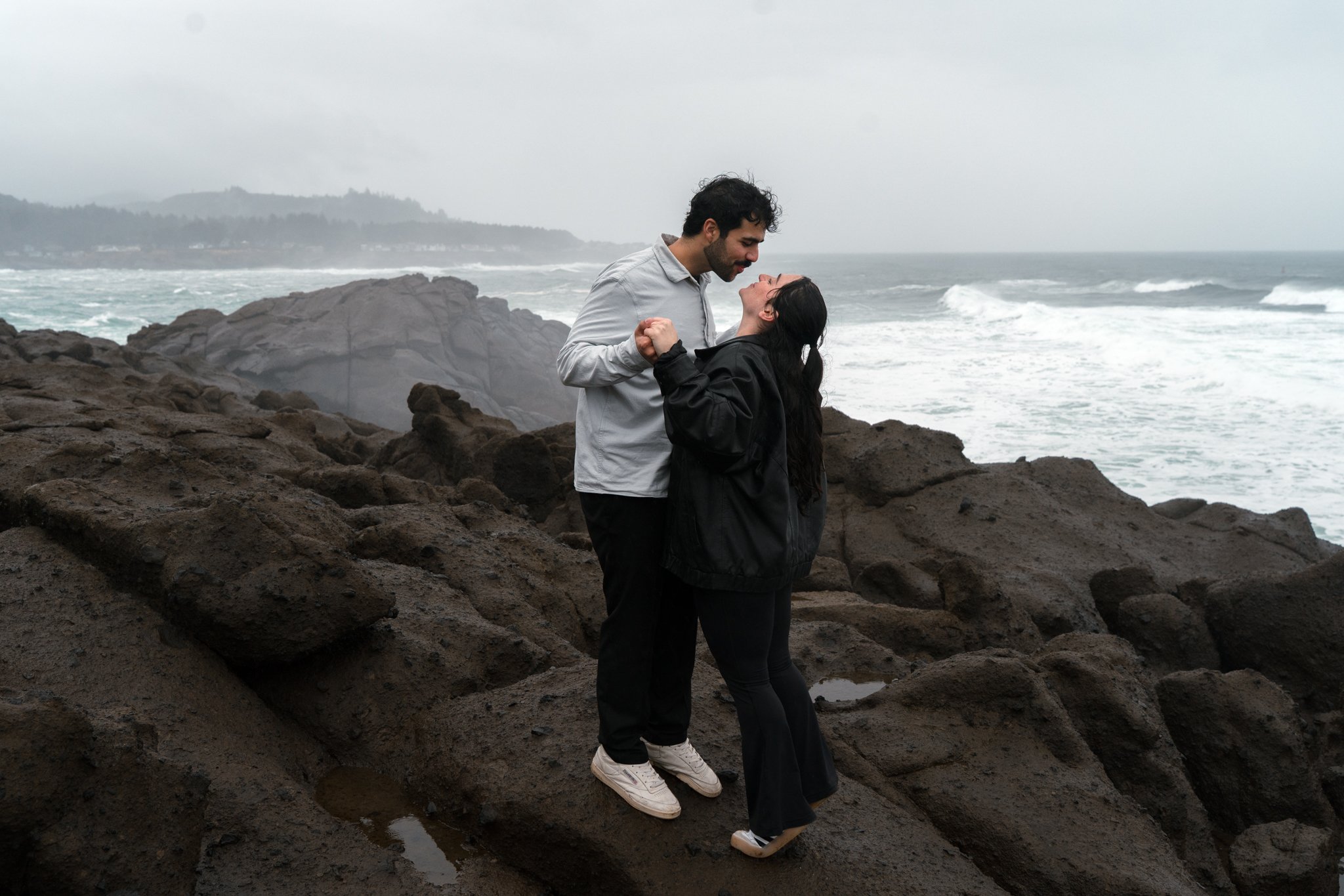 Two lovers kissing in front of their proposal photographer