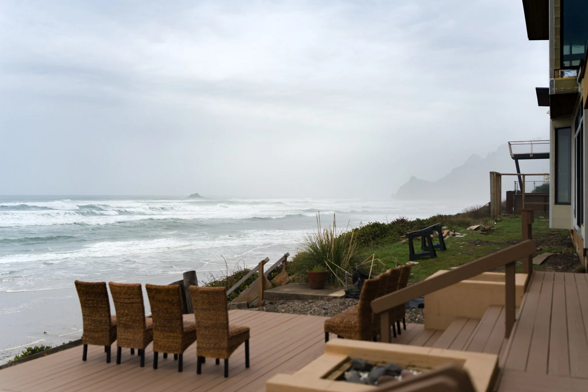 Intimate ceremony setup on a private deck in Lincoln City with panoramic views of Roads End Beach and God’s Thumb on the Oregon Coast.